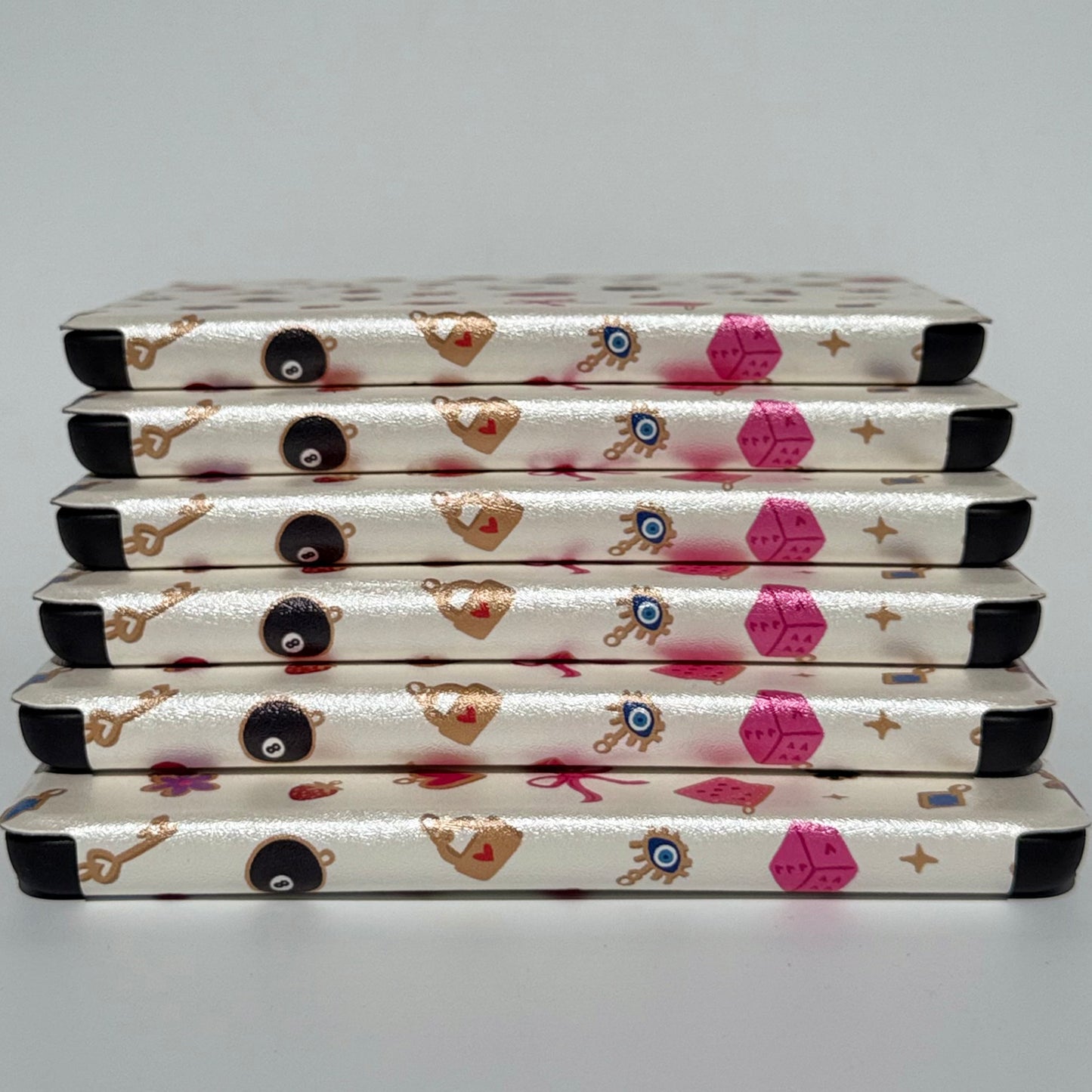 stack of pink and white kindle cases
