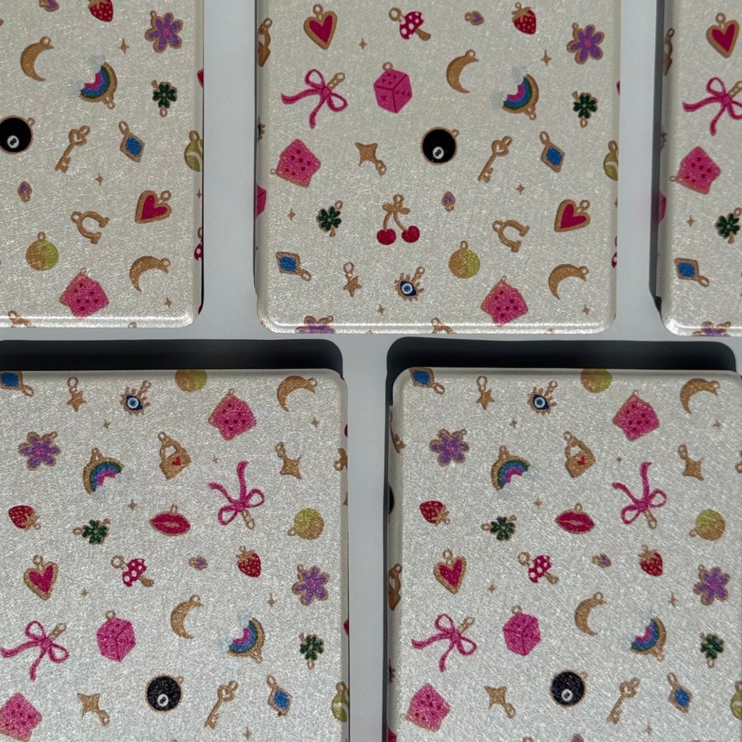 Charmed kindle case with pink charms on white background