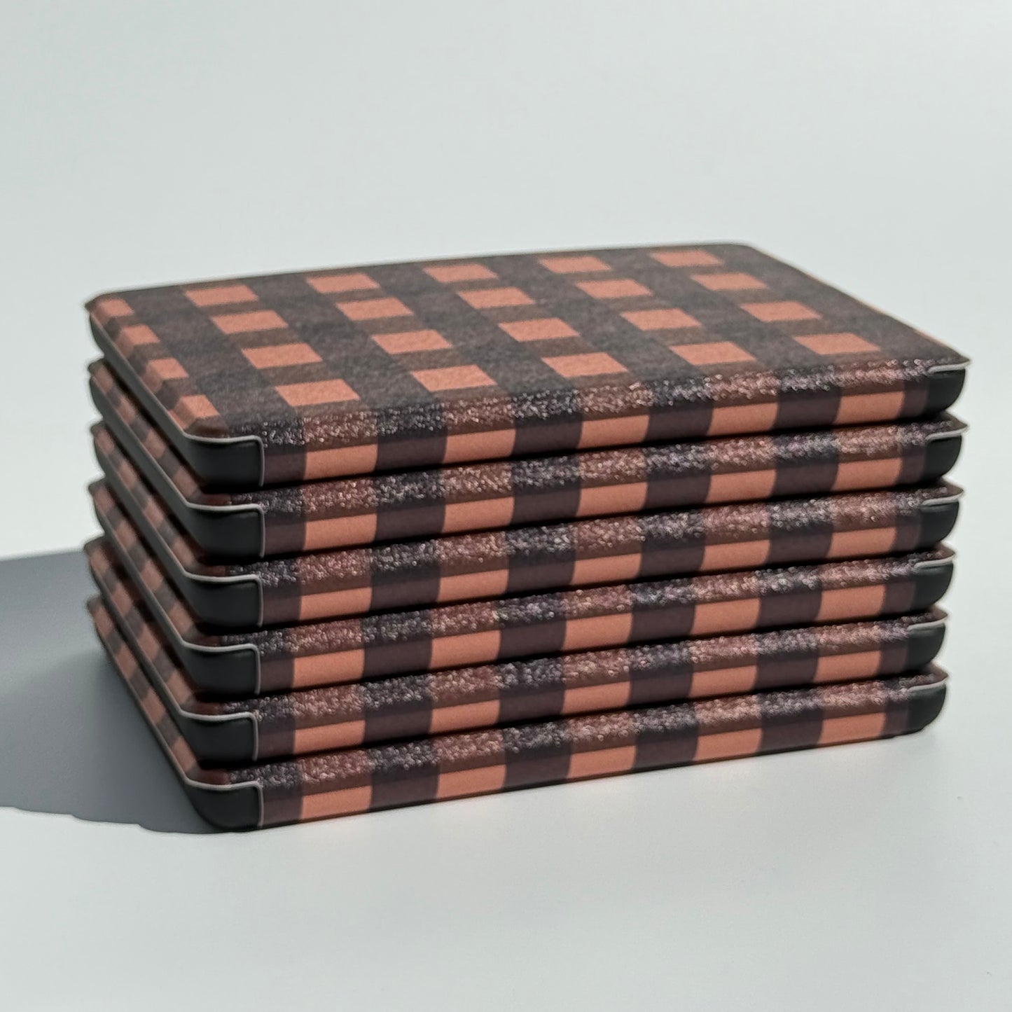 Stack of kindle cases with handstraps
