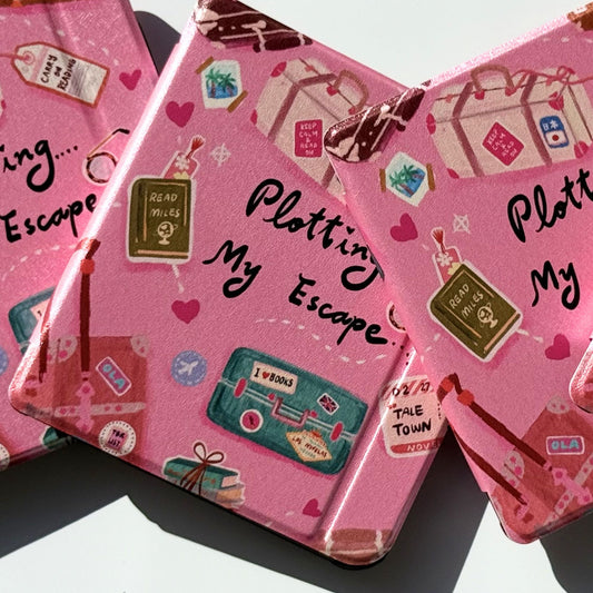 Side profile of Plotting My Escape Kobo Libra cases stacked, showing shockproof black bumper and pink book lover print