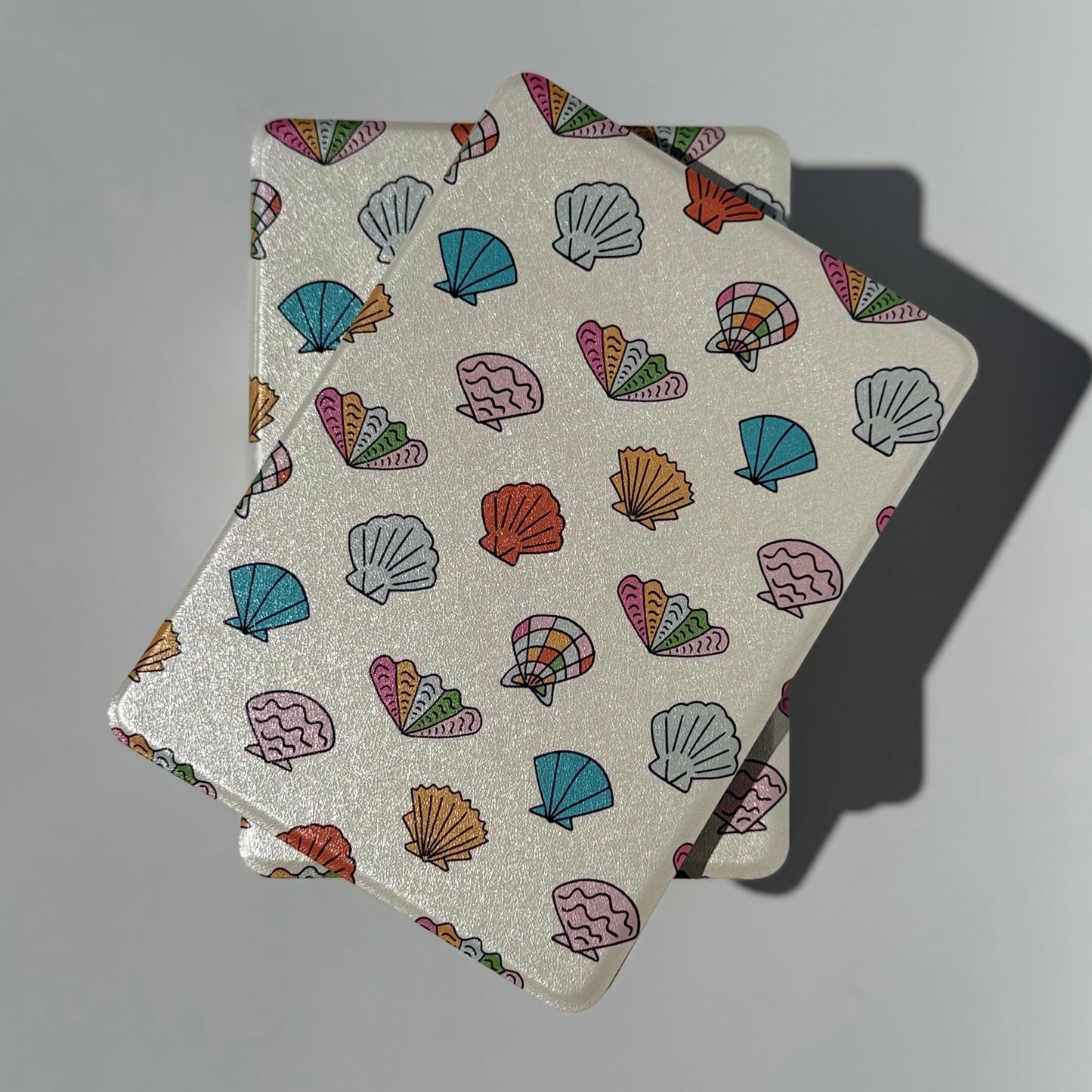 Pastel kindle case stacked on white background