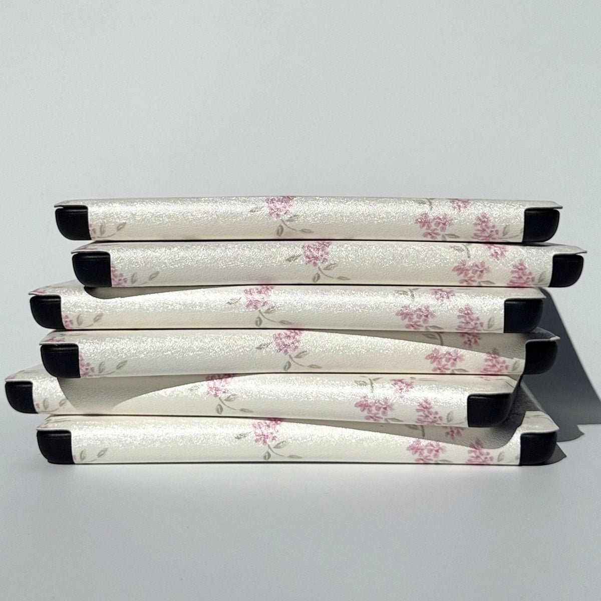 Stack of Blooming floral Kindle cases on their sides, from Case Society Australia