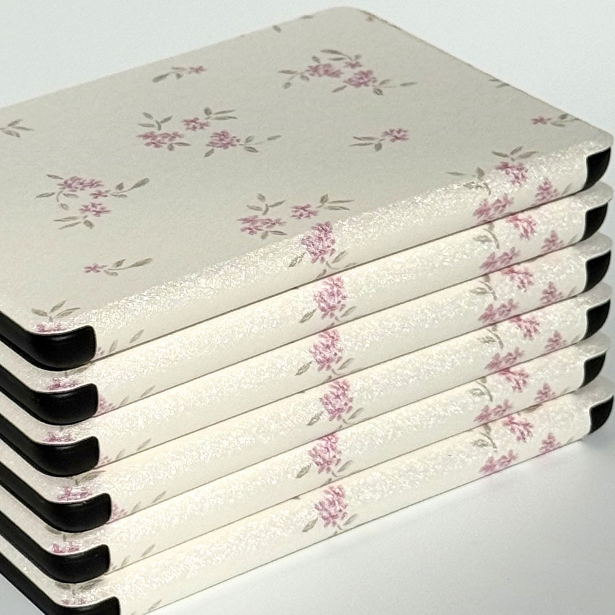 Blooming vintage floral Kindle Paperwhite cases stacked at an angle