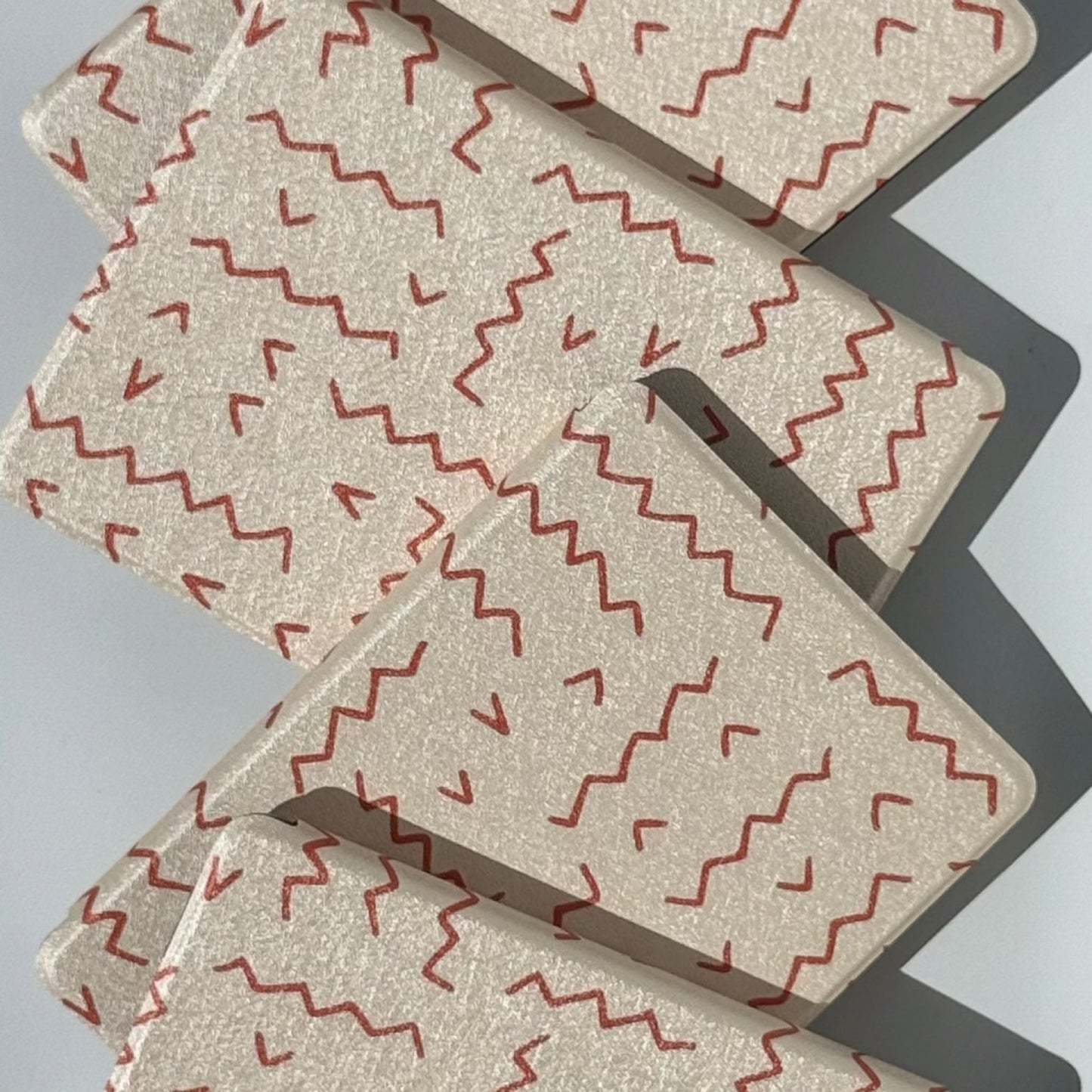 Between The Lines Kindle case, hand-drawn red squiggles on warm oatmeal, artistic aesthetic Kindle cover