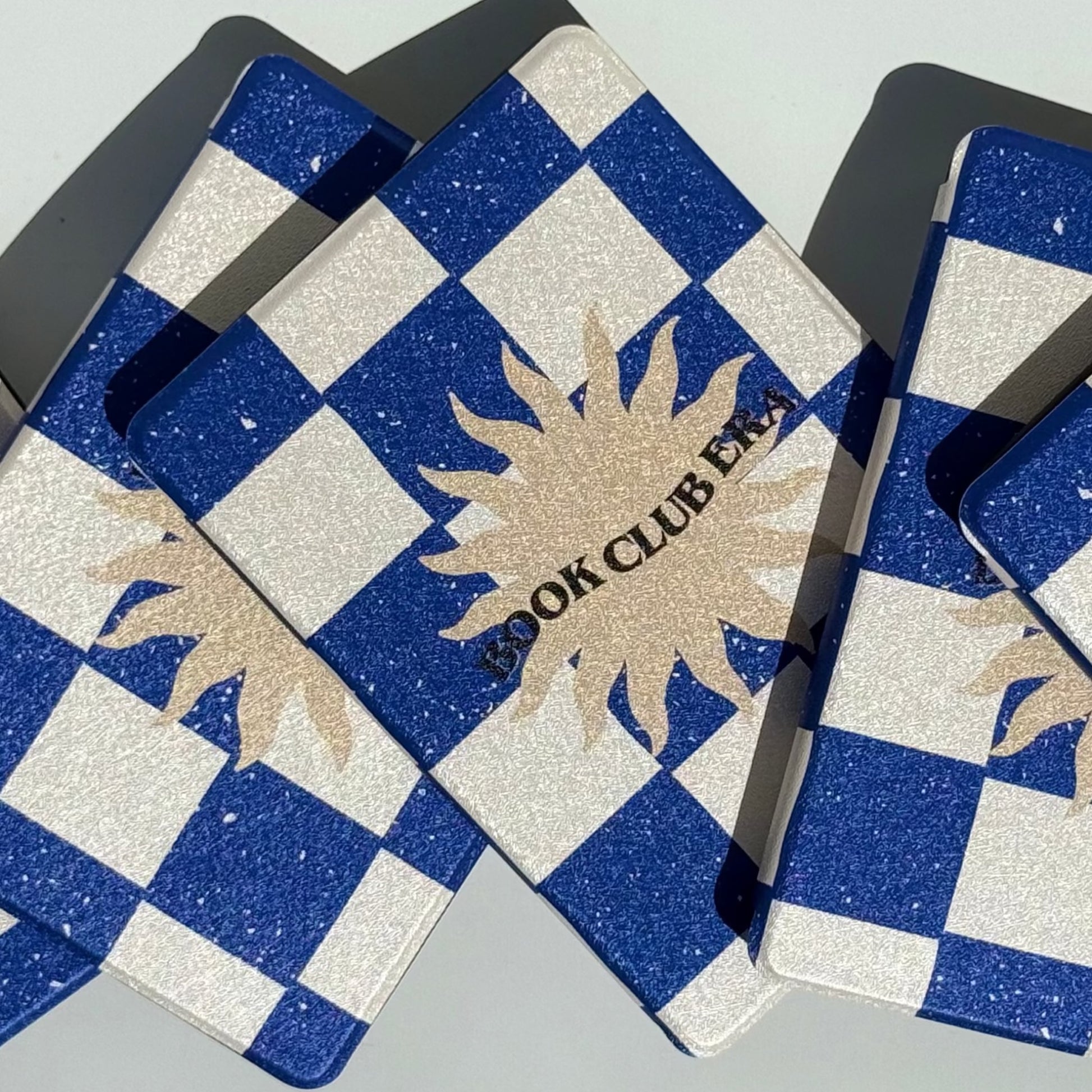 Spread of Book Club Era navy checkerboard Kindle cases