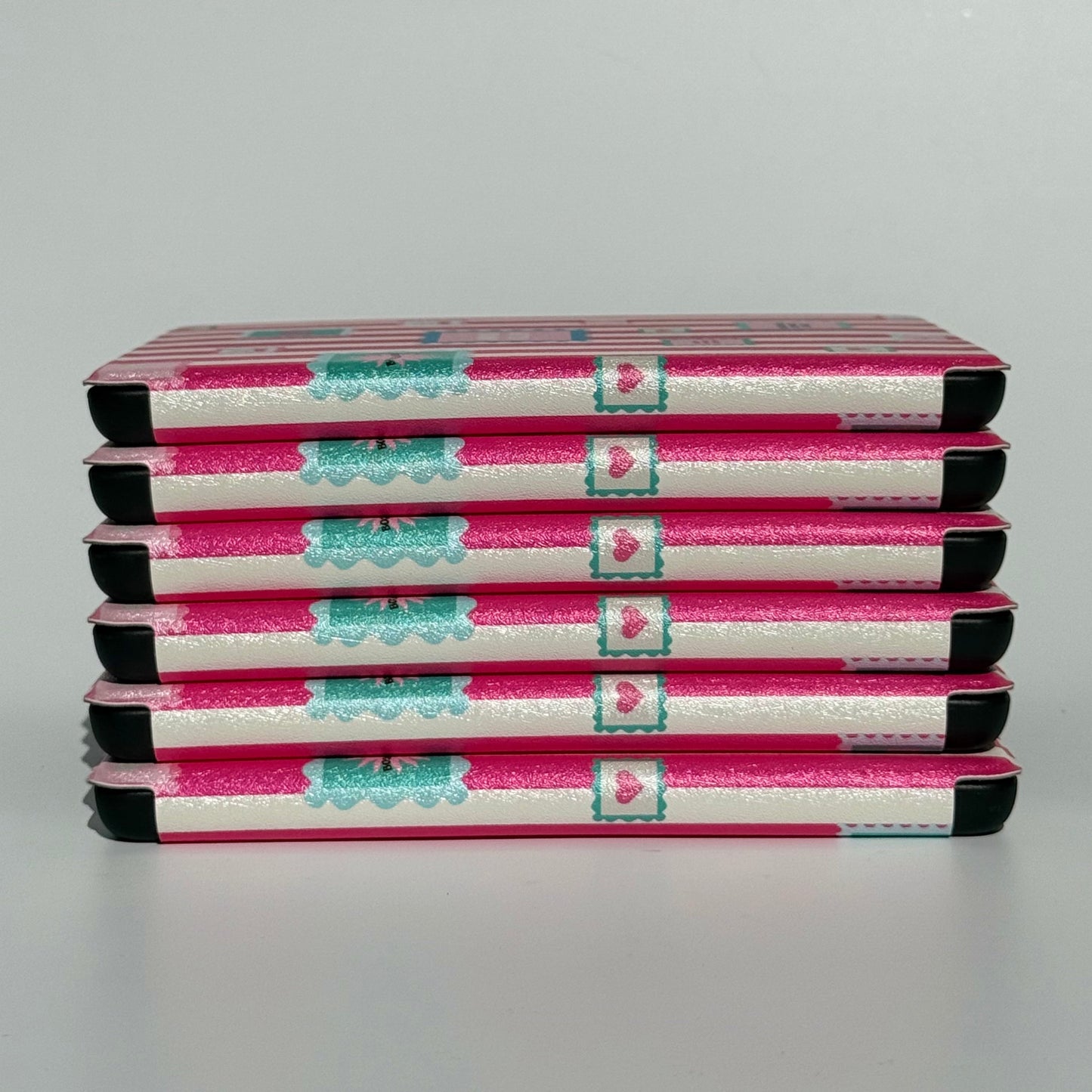 Group of Booking Hearts pink stripe Kindle cases with hand strap