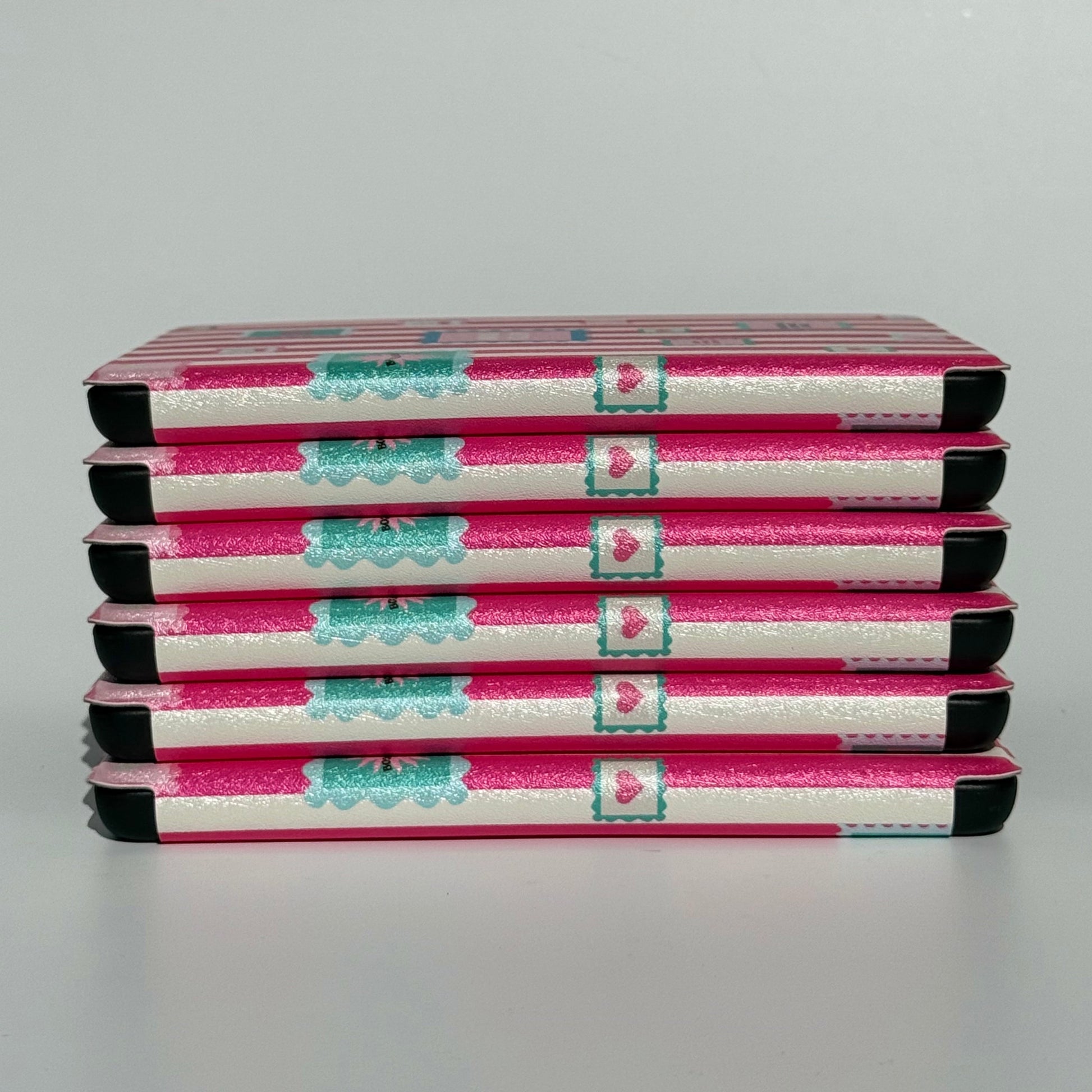 Group of Booking Hearts pink stripe Kindle cases with hand strap