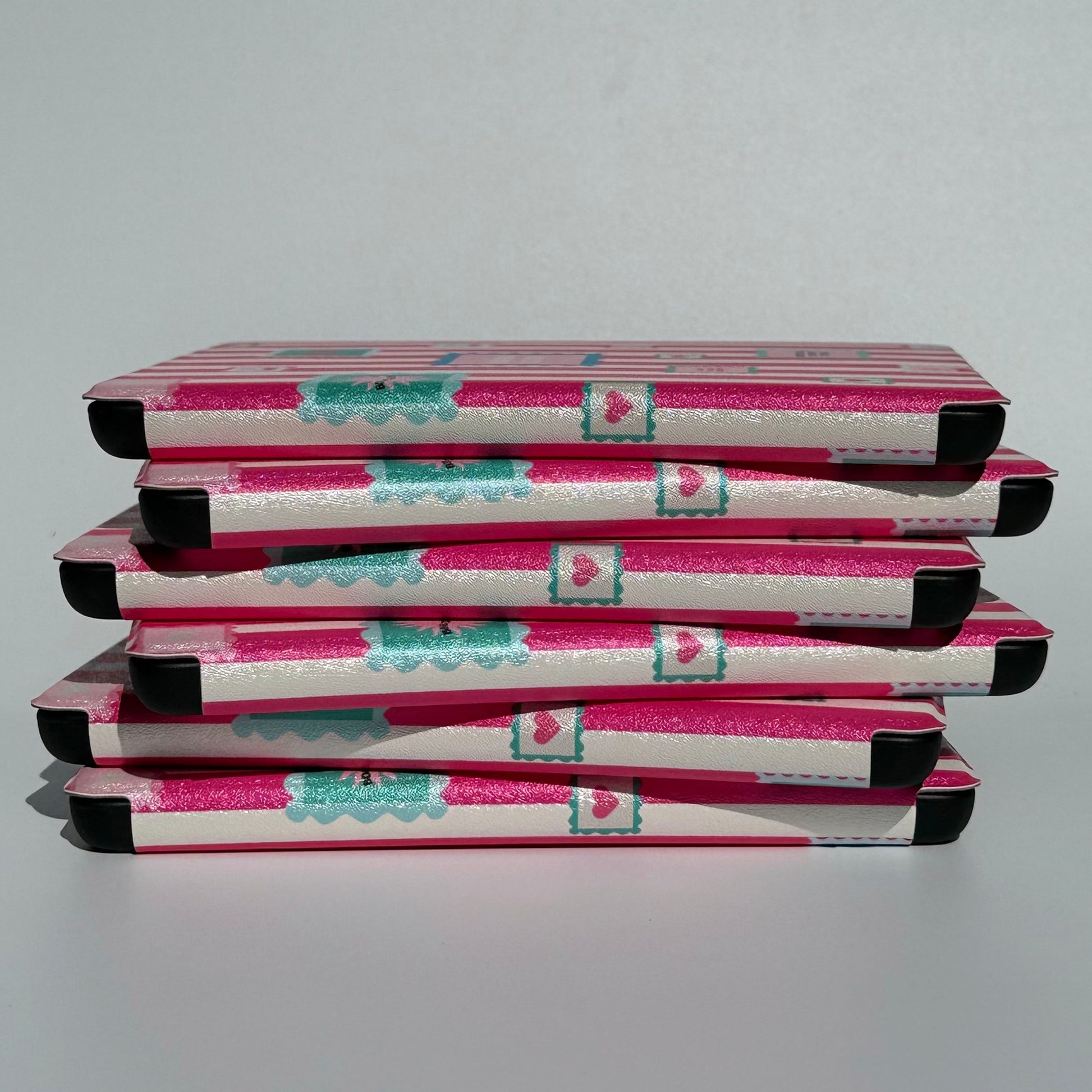 Side view of the Booking Hearts pink stripe Kindle case