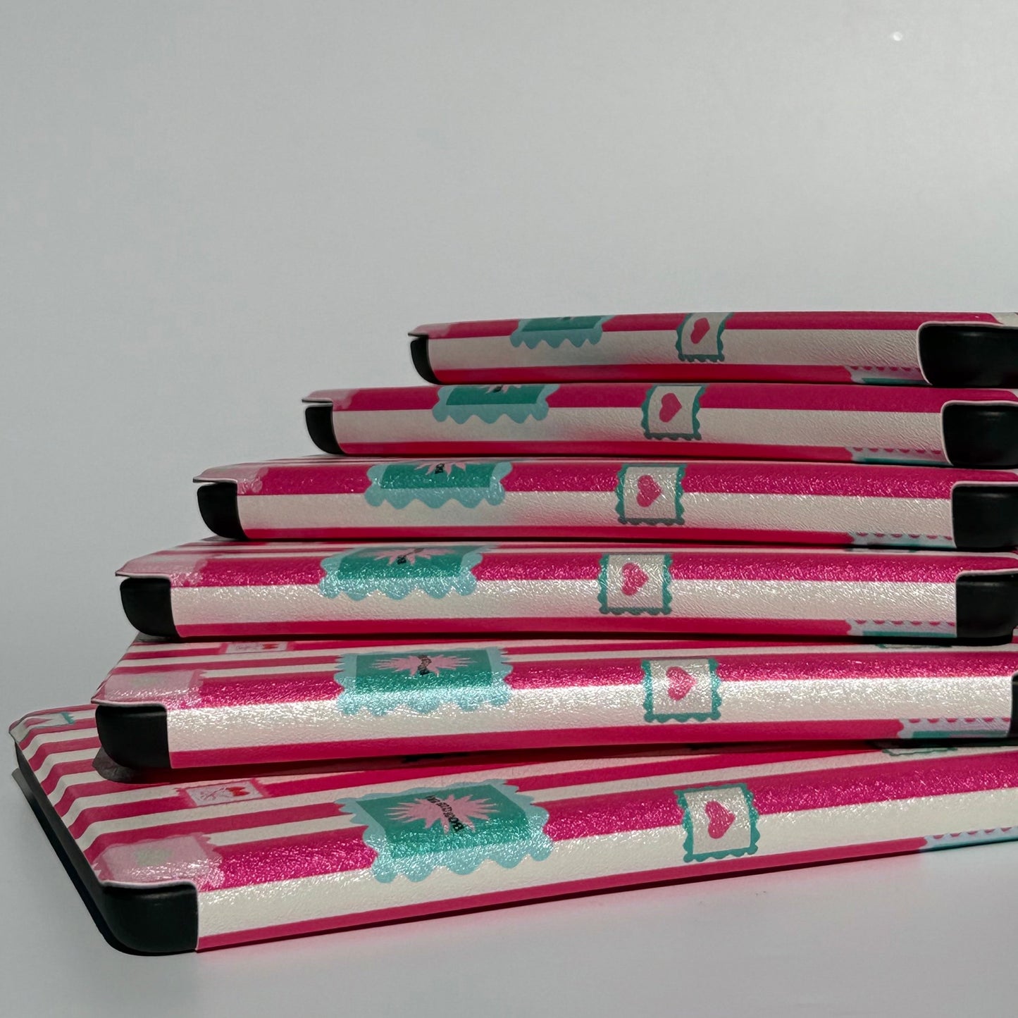 Splay of Booking Hearts pink stripe Kindle cases, Case Society Australia