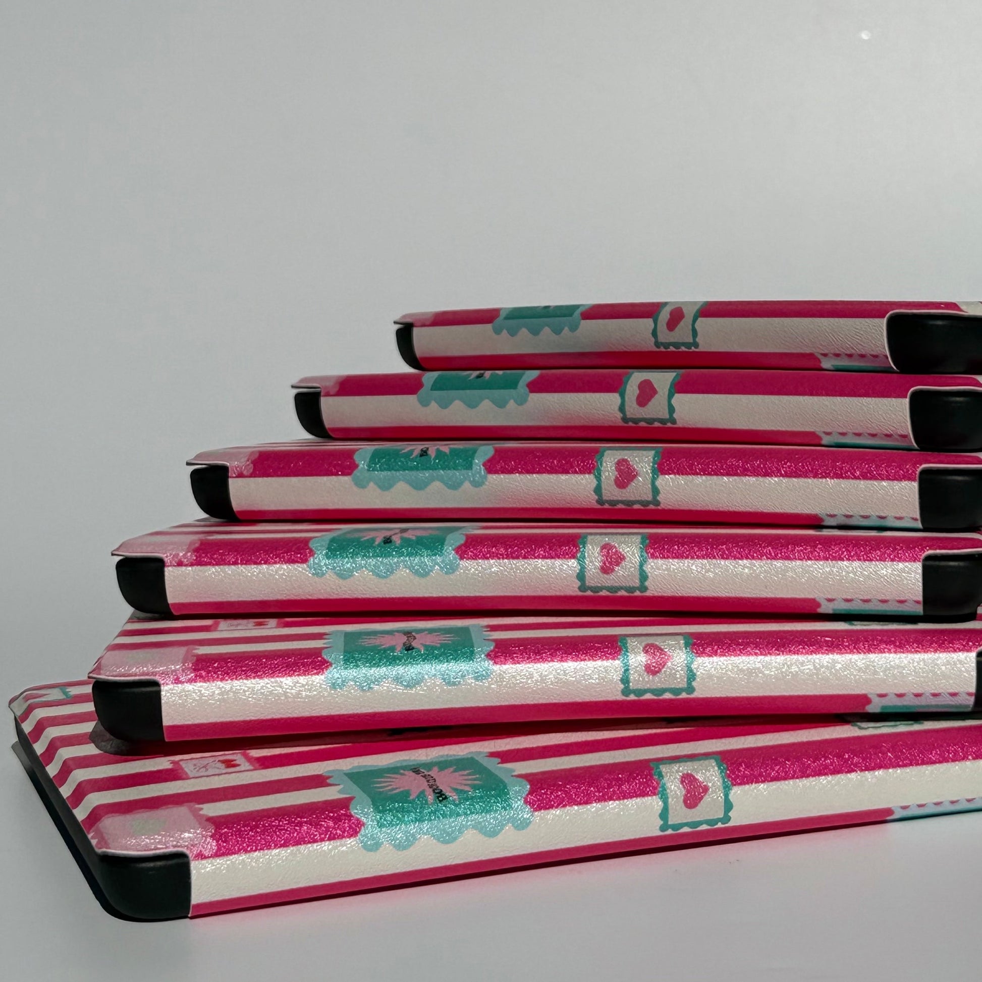 Splay of Booking Hearts pink stripe Kindle cases, Case Society Australia