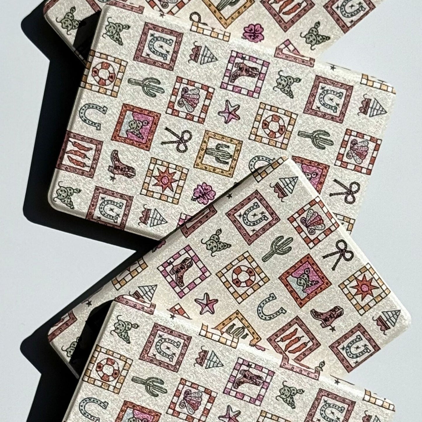 Patterned Kindle case with cactus horseshoe and cowboy boot design