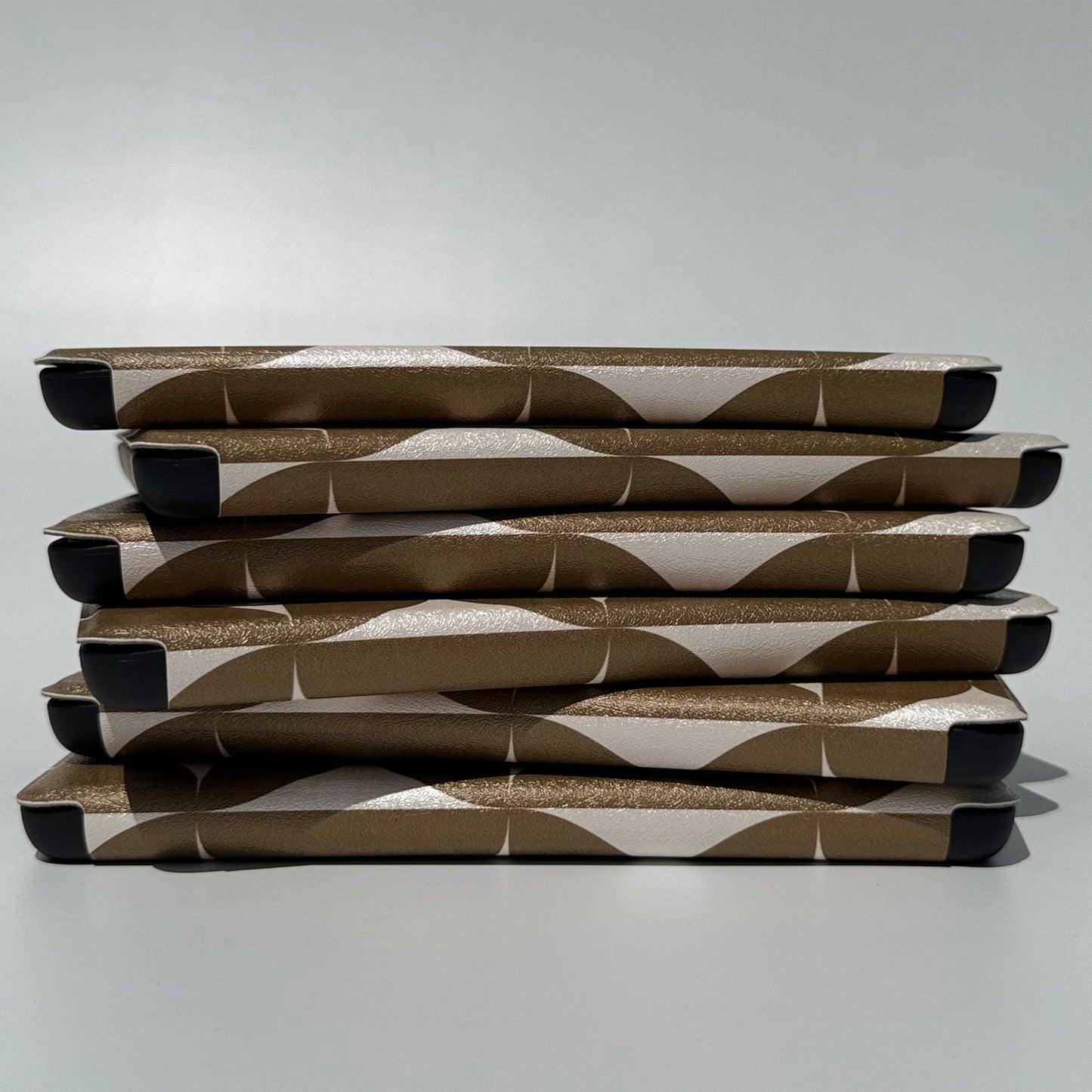 Case Society Olive Chip Kindle Case - spine view of stack of kindle cases