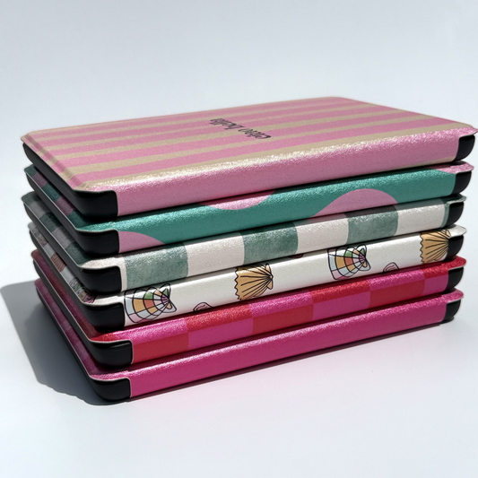 Stacked colourful Kindle cases by Case Society Co showing aesthetic patterned e-reader covers