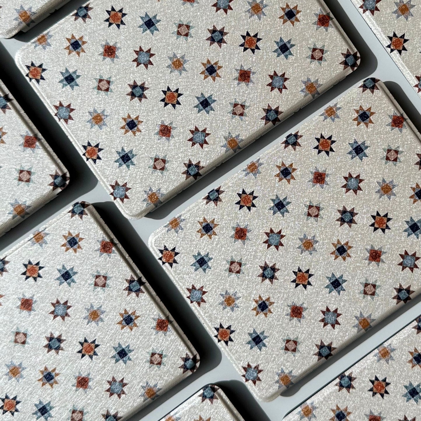 Stack of Everloom cream folk star Kindle cases