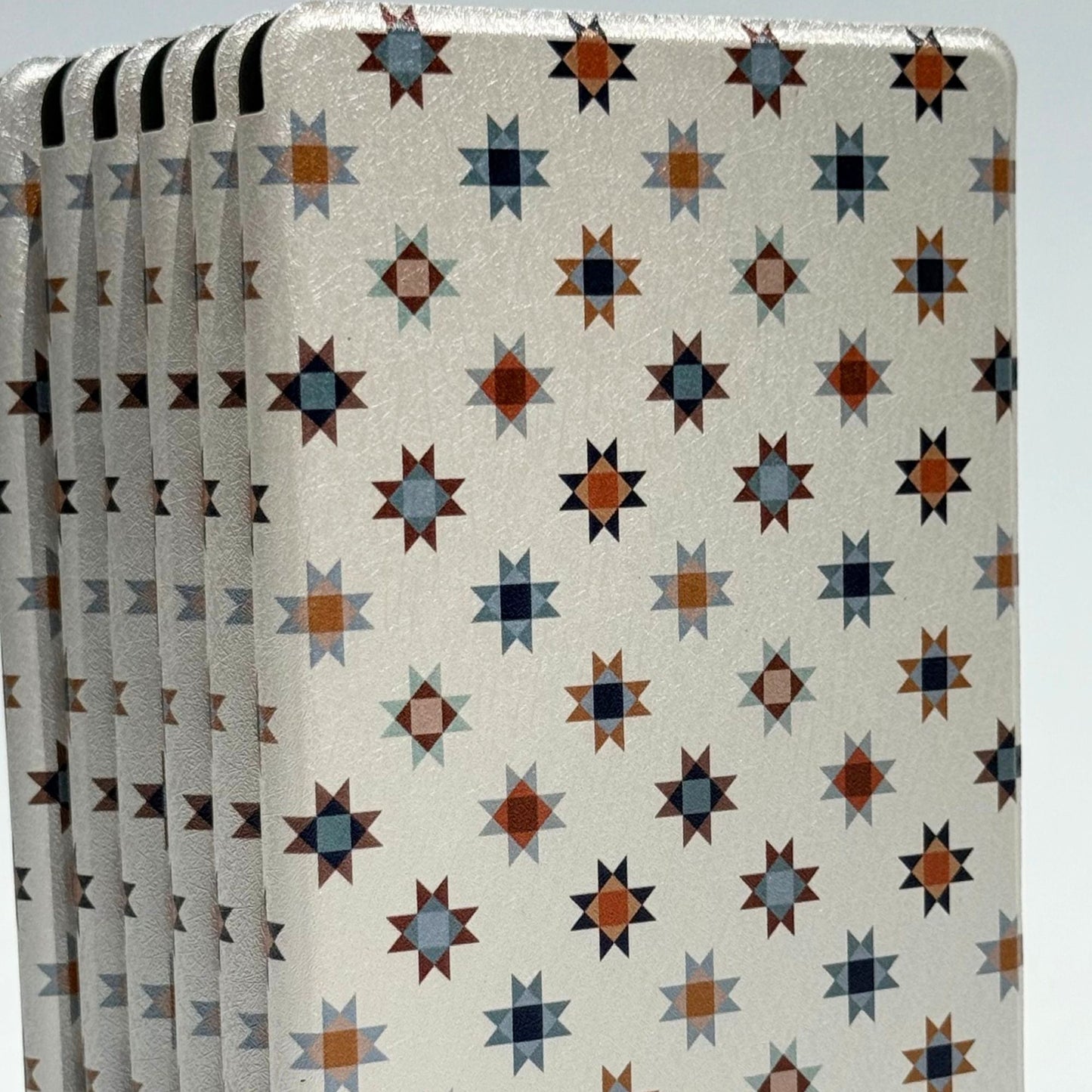 Everloom folk star Kindle case standing, navy and rust on cream