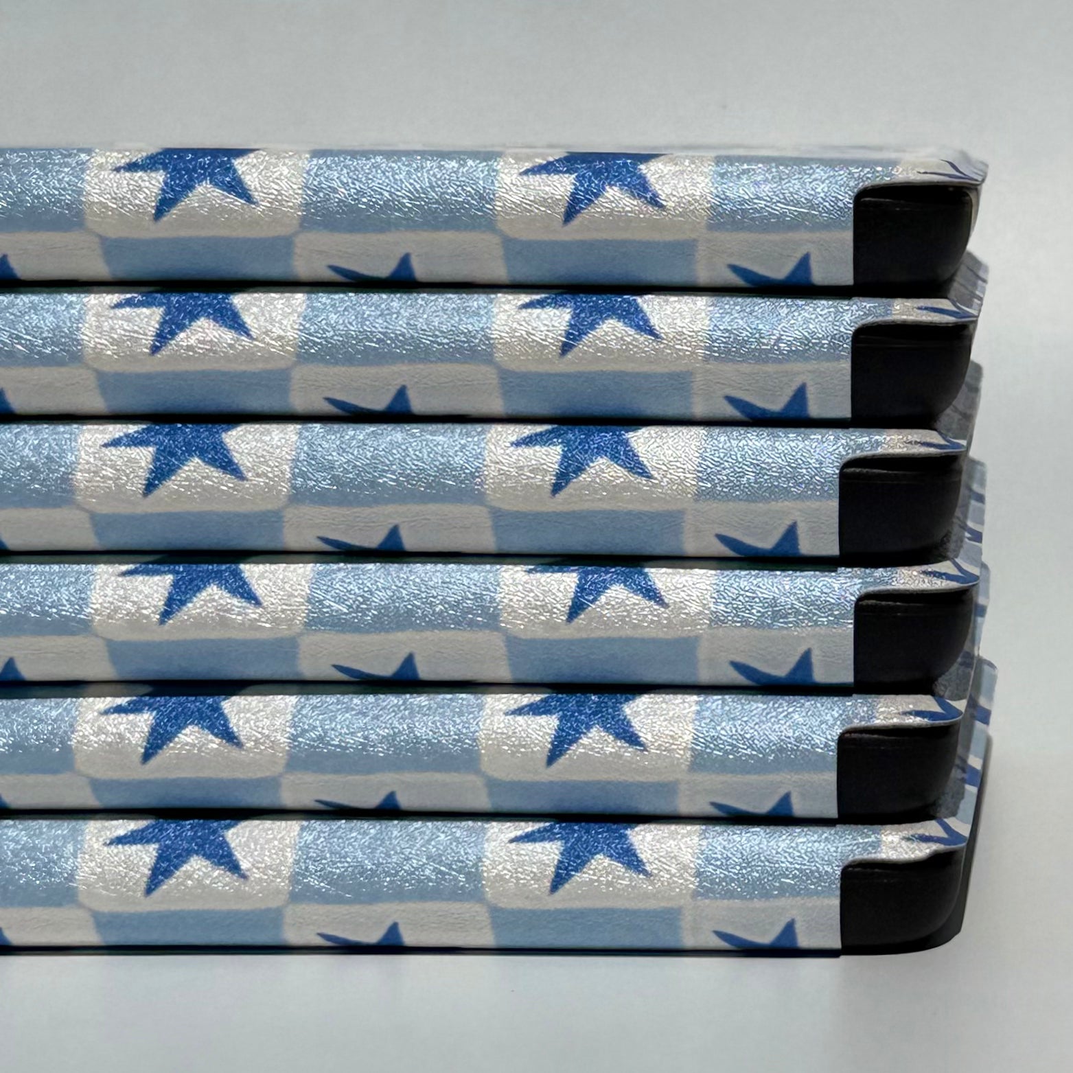 blue and white kindle cases stacked on white background