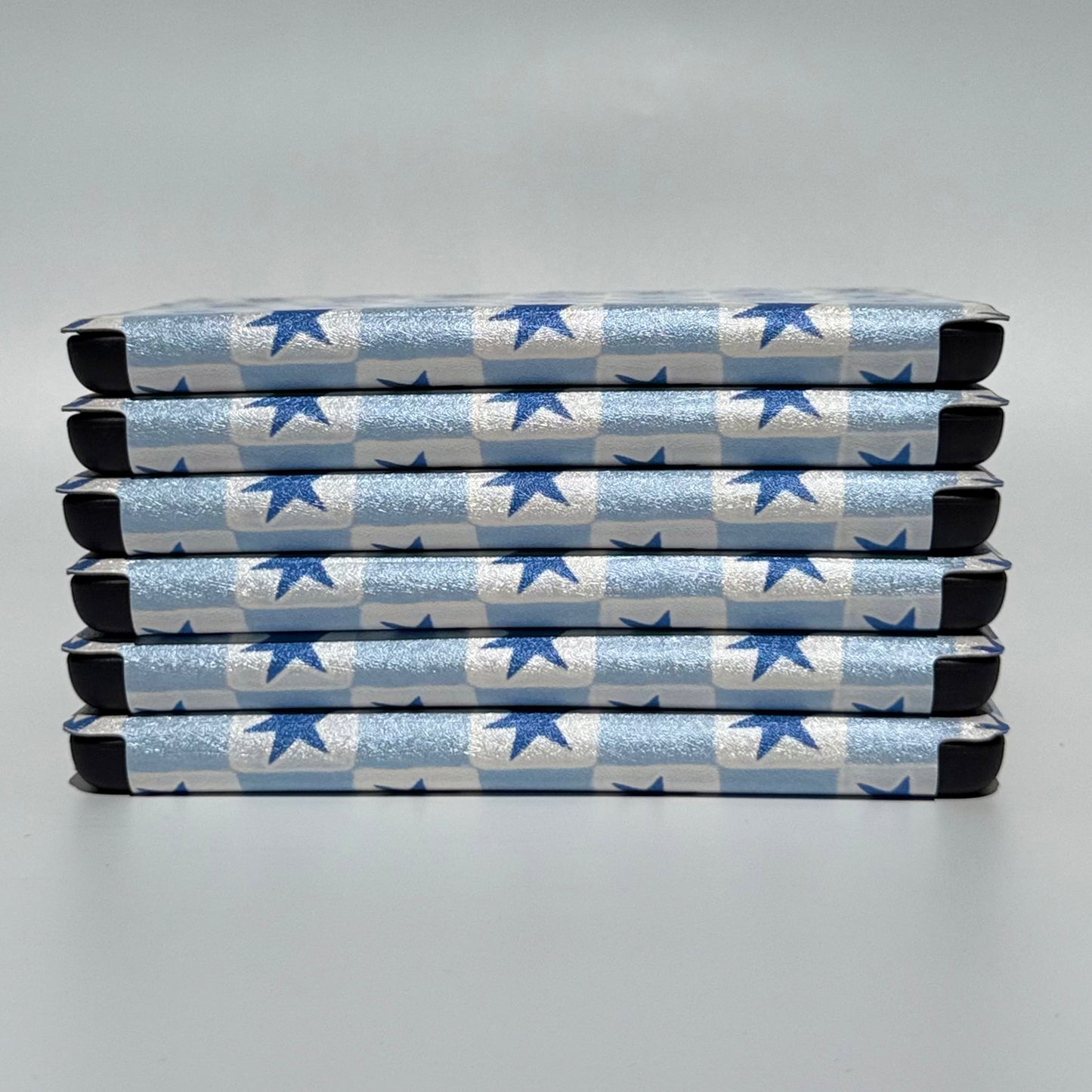 Blue and white checkered kindle cases stacked 