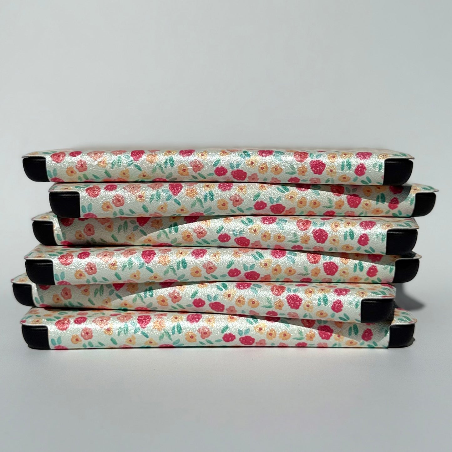 stack of floral Kindle Cases with flowers