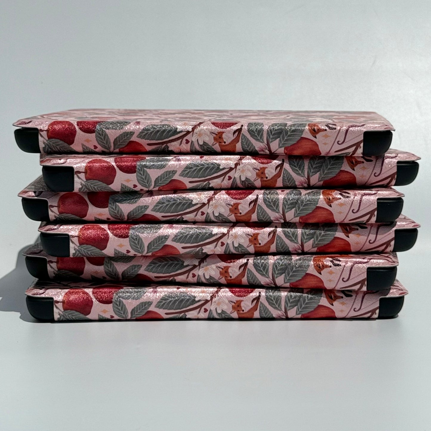 stack of floral kindle cases with handstraps
