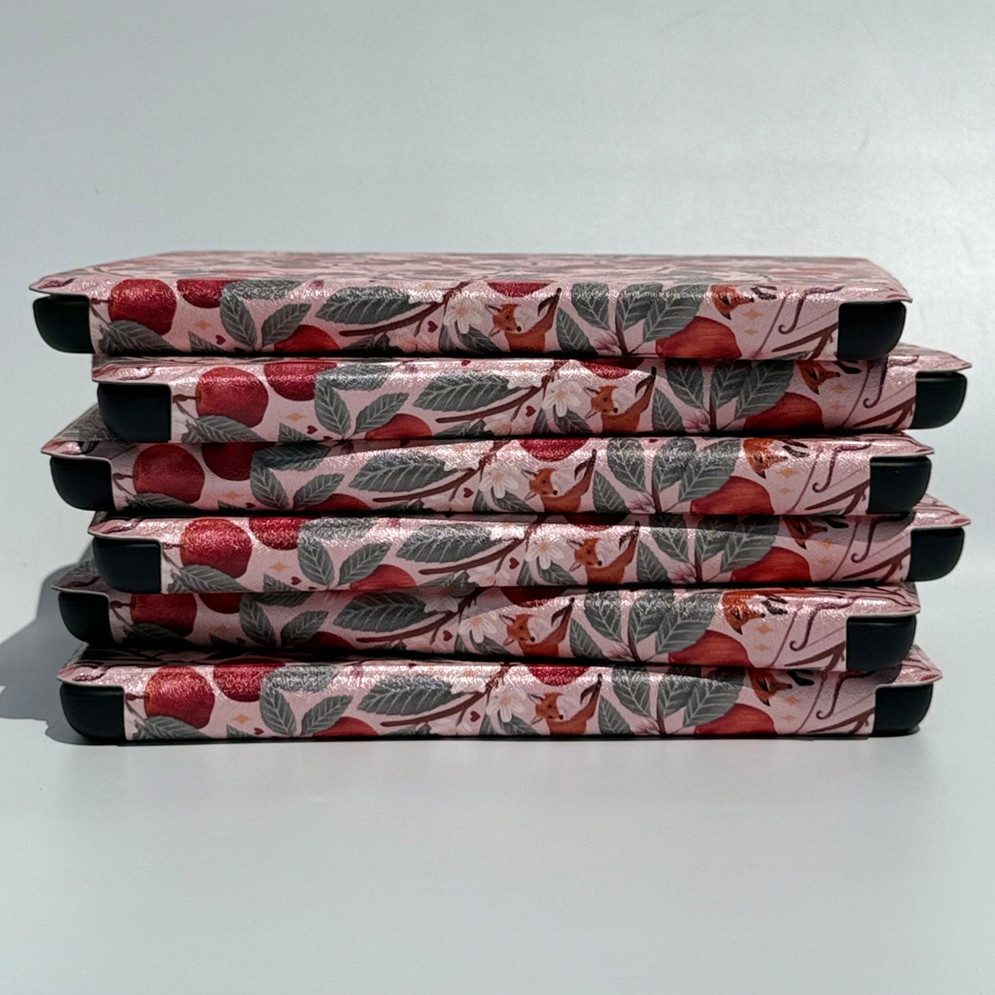 stack of floral kindle cases with handstraps