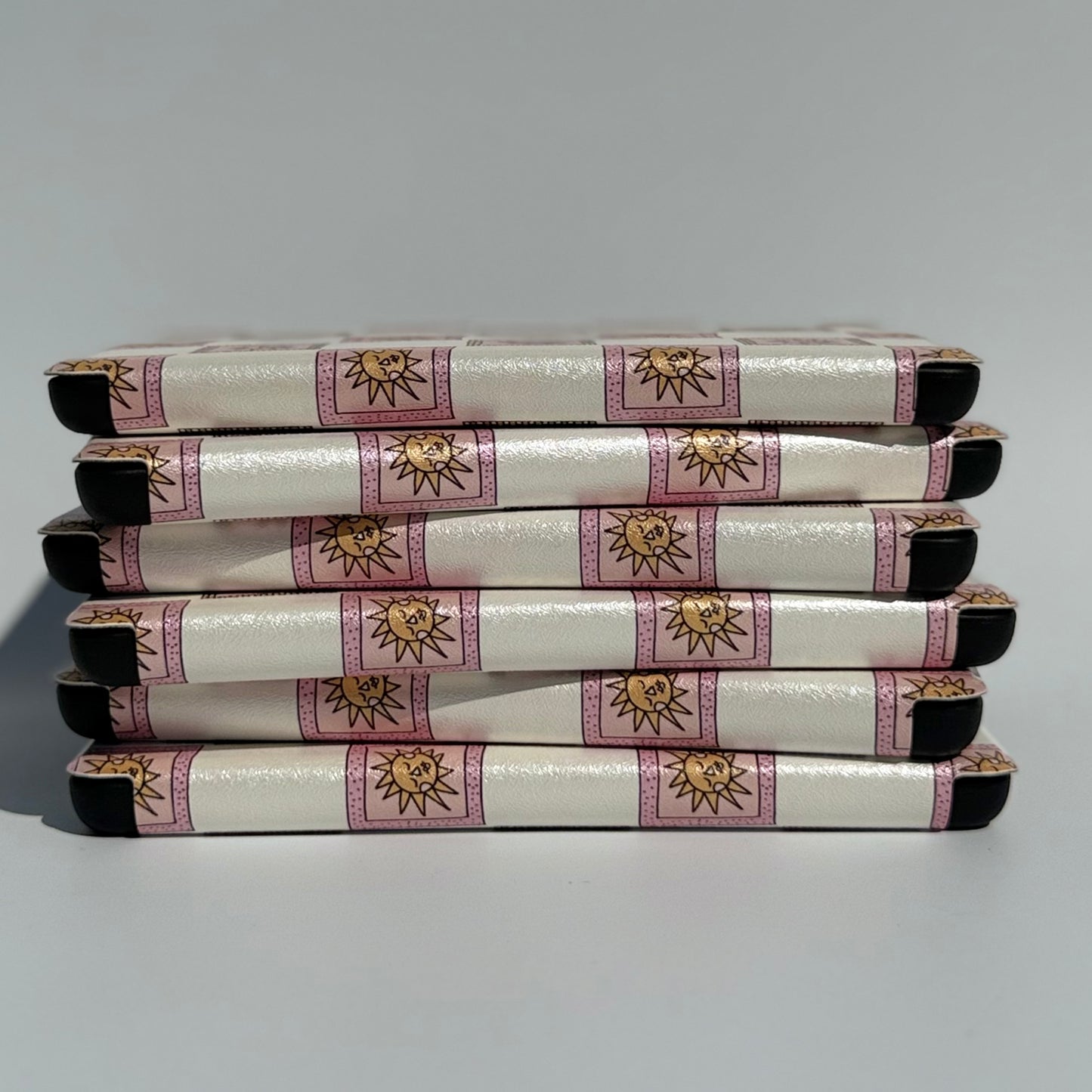 Stack of cute pink kindle cases with handstraps