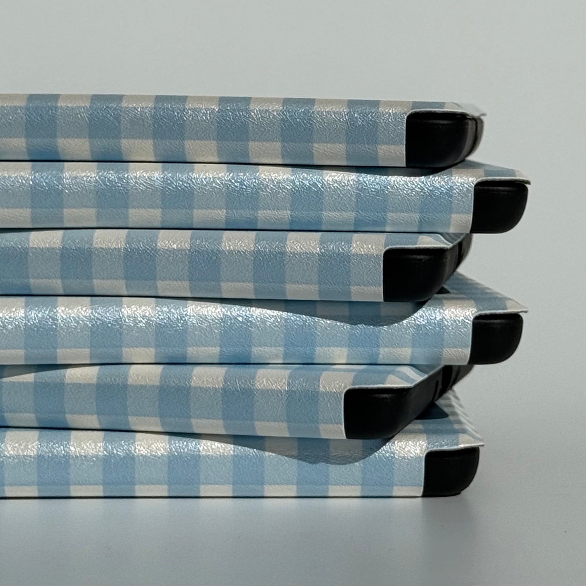 Side view of The Quiet Blue blue gingham Kindle case with auto sleep/wake
