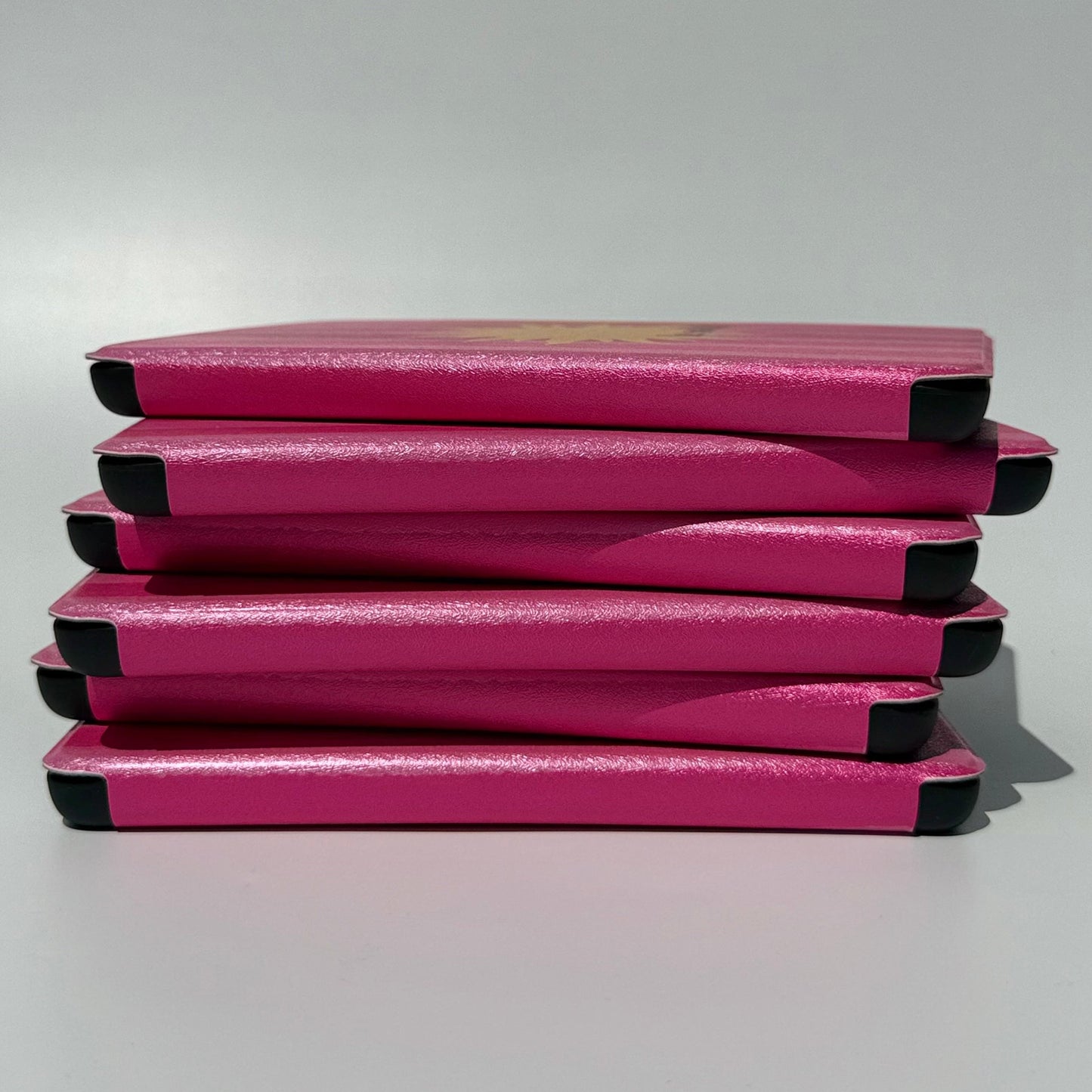 Side stack of Le Soleil striped Kindle cases showing the slim profile