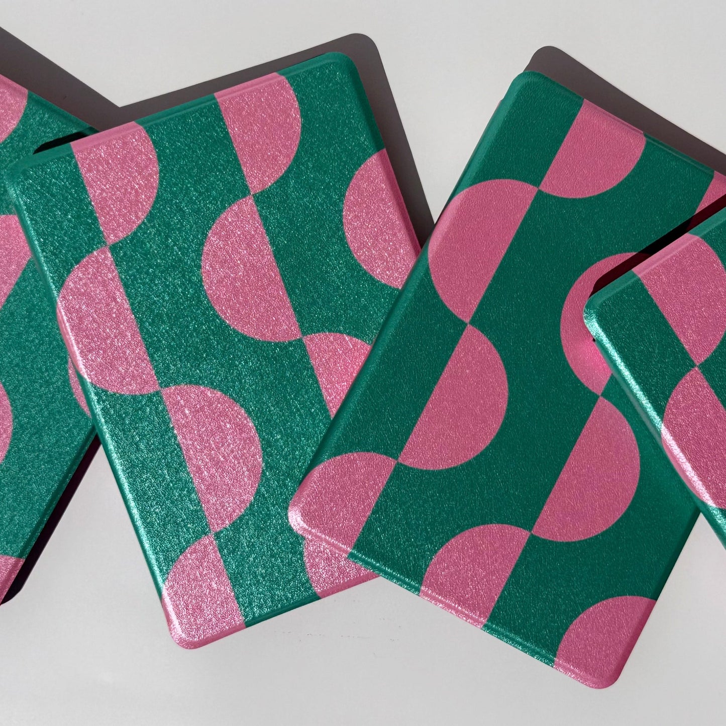 Pink Crescent green and pink crescent Kindle cases from above, for Kindle Paperwhite