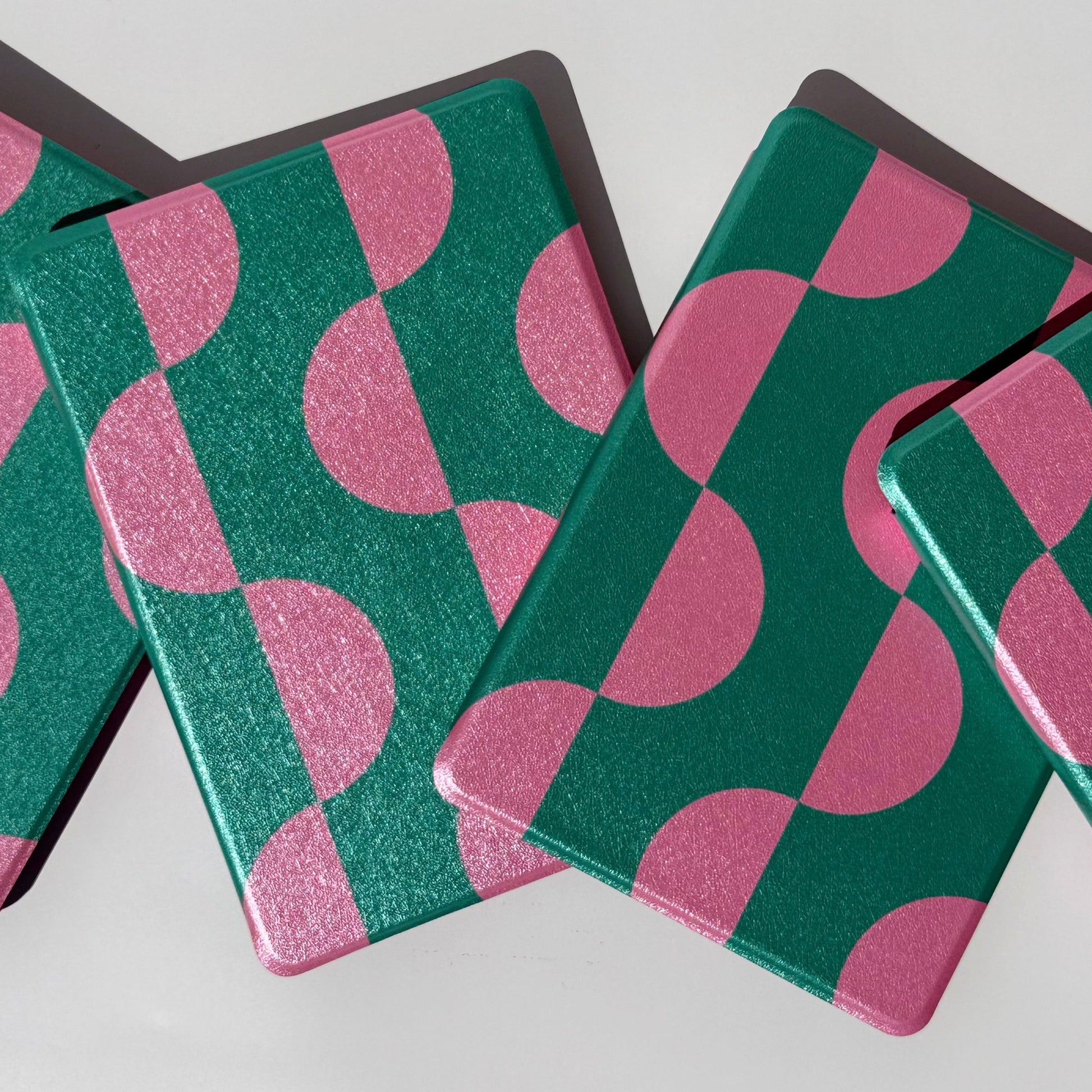 Pink Crescent green and pink crescent Kindle cases from above, for Kindle Paperwhite
