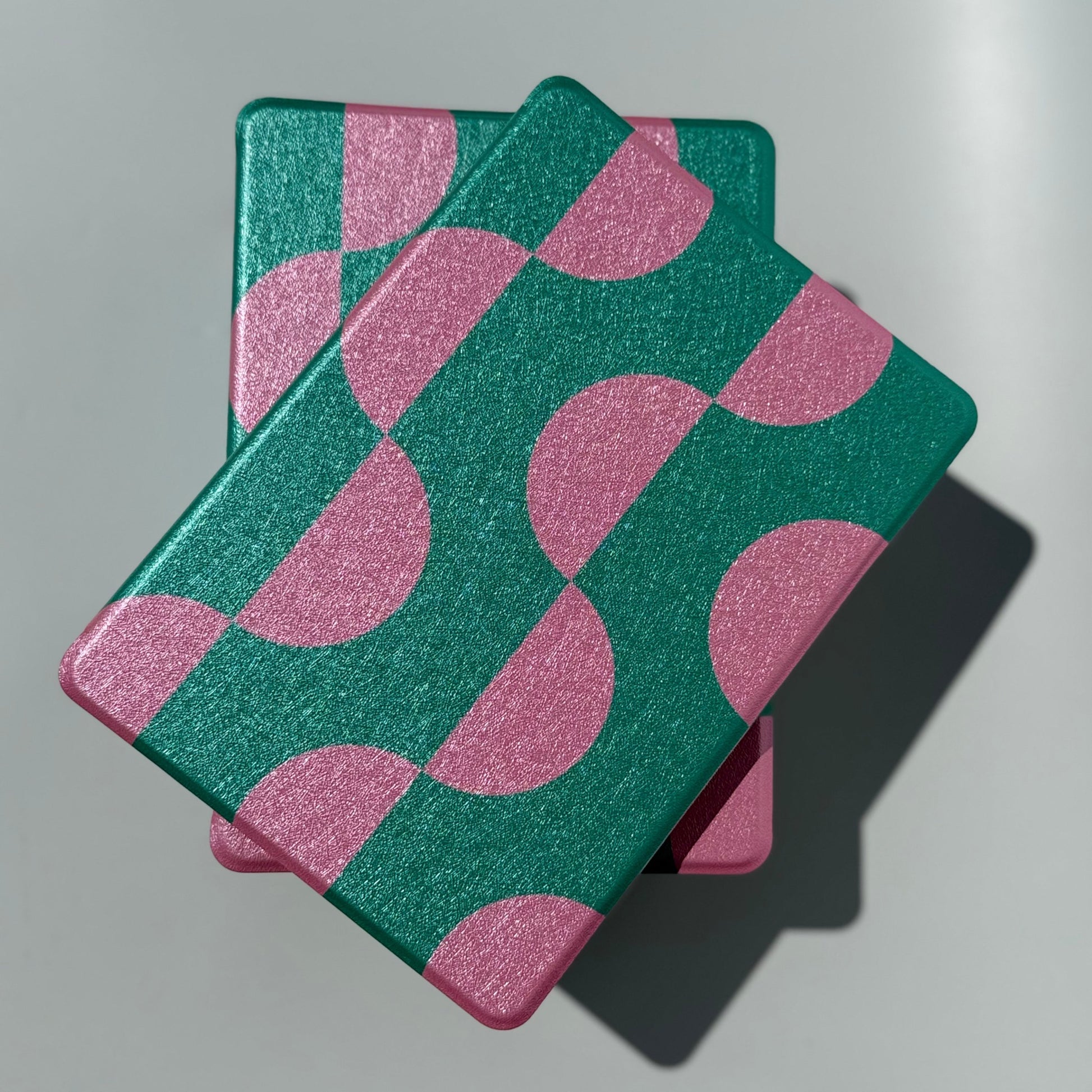 Top view of the Pink Crescent geometric Kindle case in green and pink