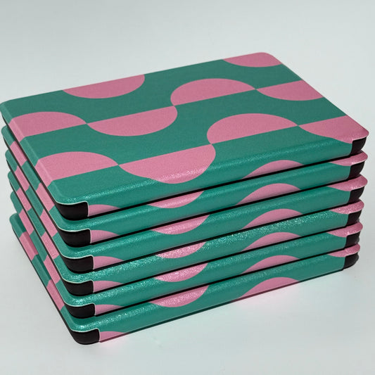 Stack of Case Society Pink Crescent kindle cases from side angle 