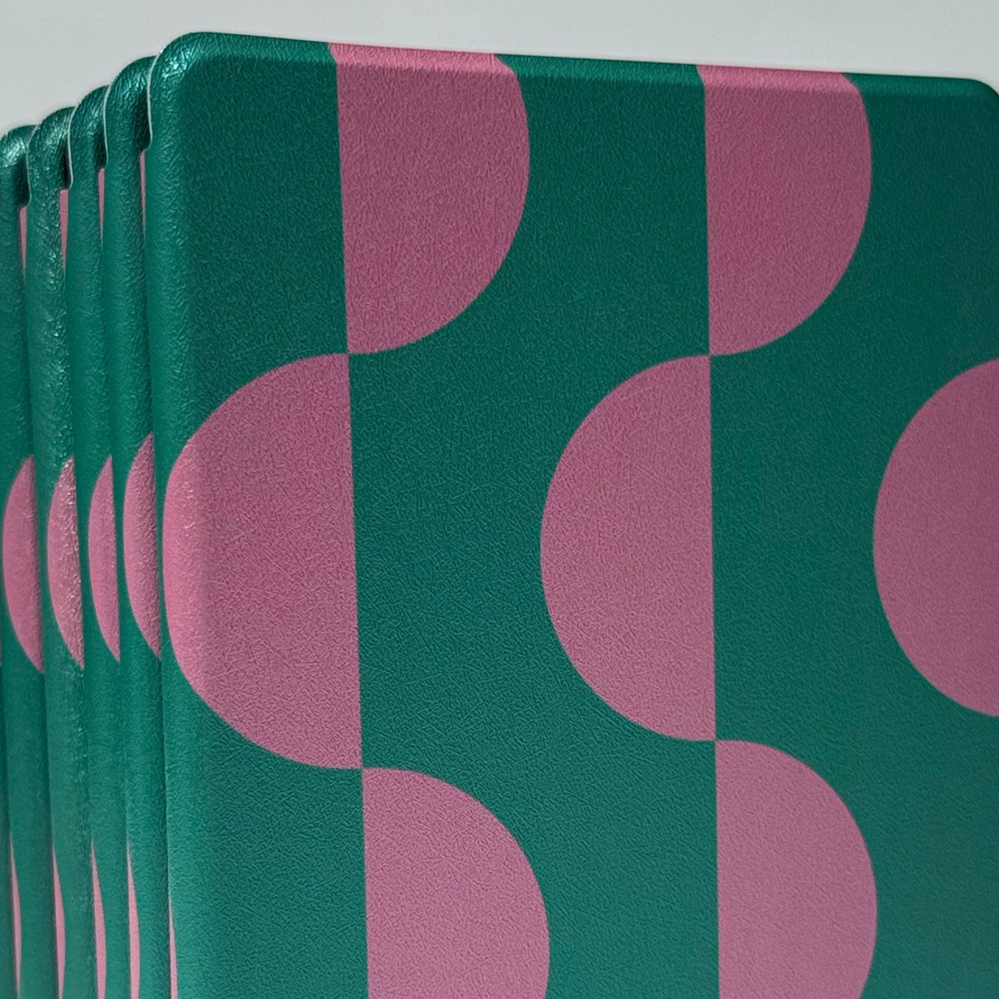 Front view of Case Society Pink Crescent kindle case pink and green stack of cases