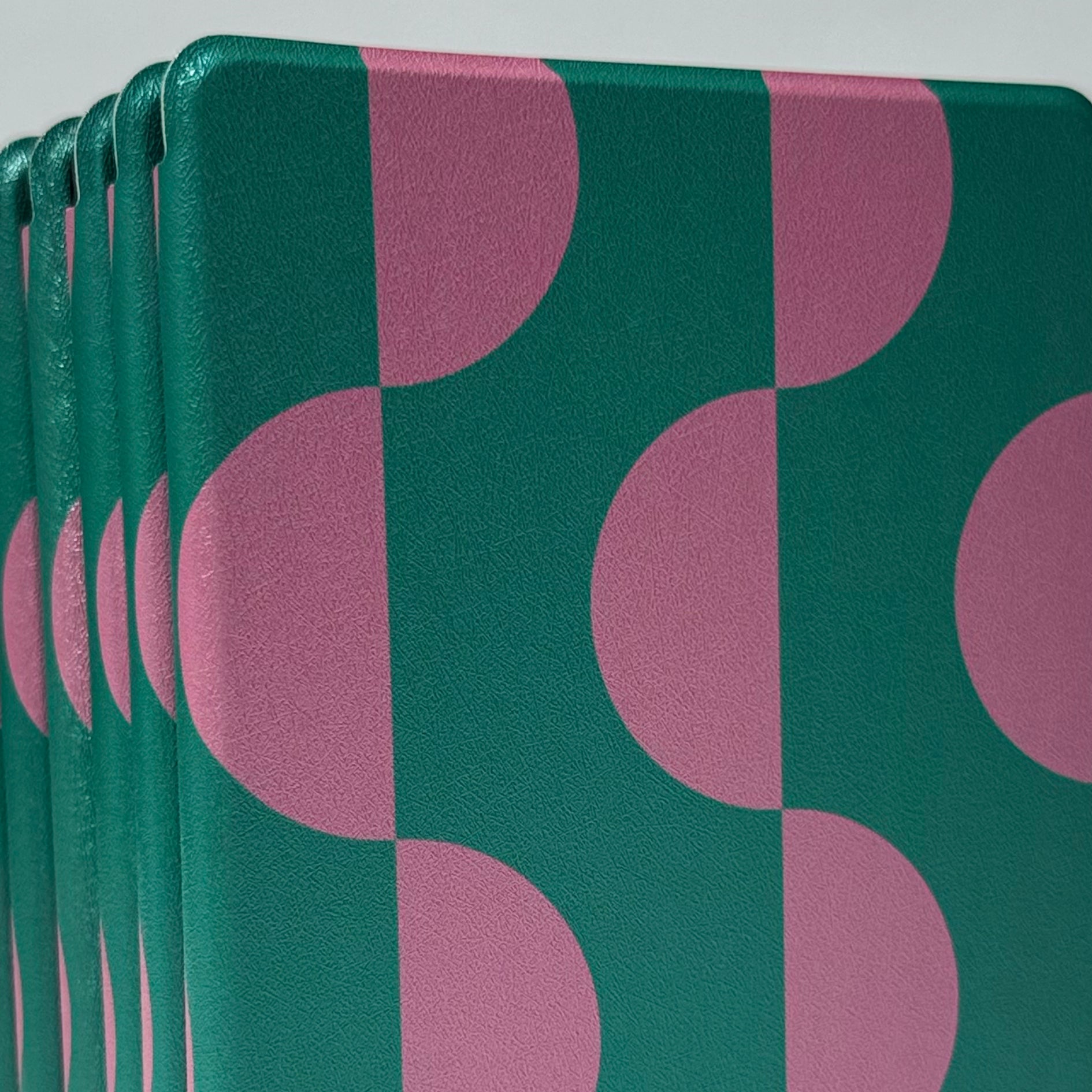 Front view of Case Society Pink Crescent kindle case pink and green stack of cases