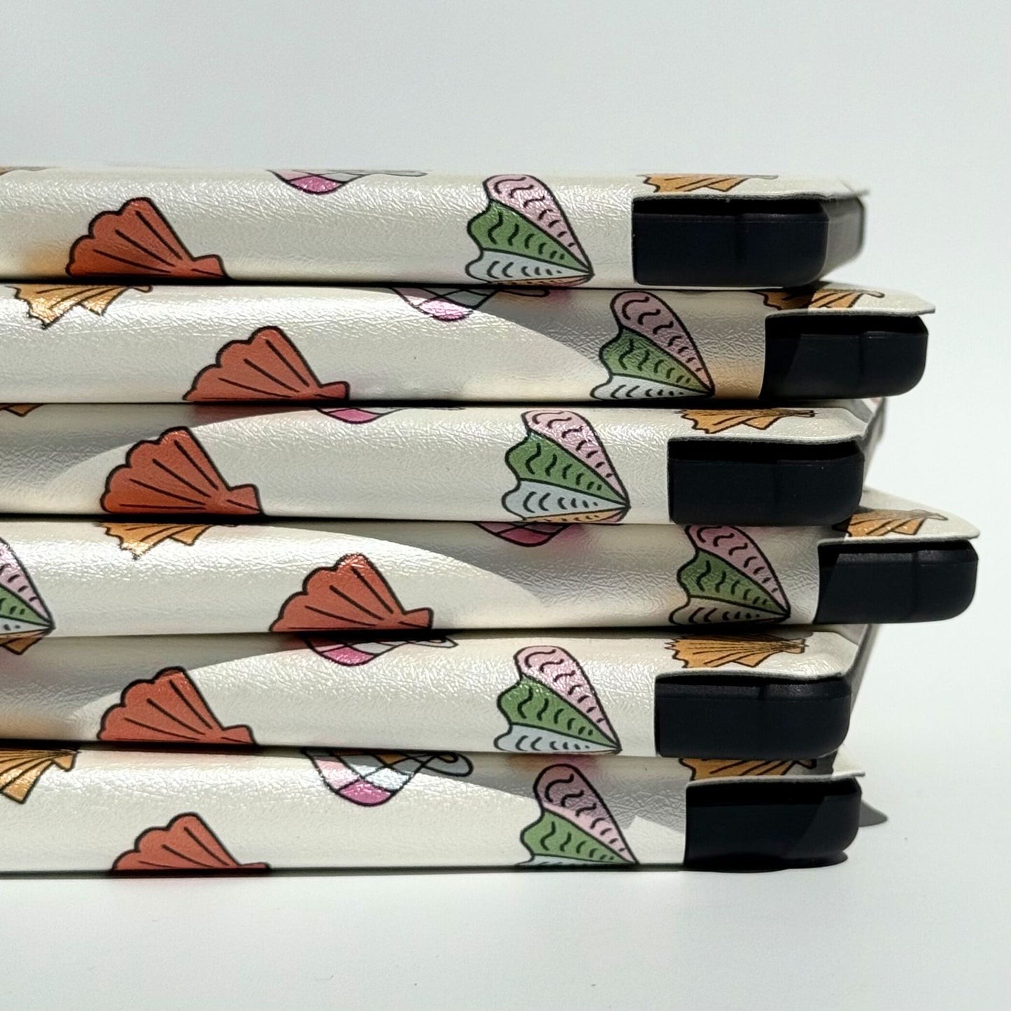 Right side stack of Shores Of Ophelia seashell Kindle cases