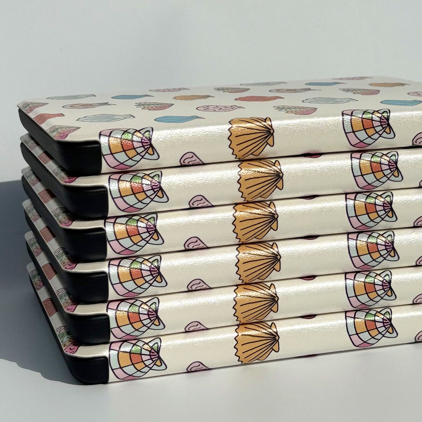 Stack of Shores Of Ophelia seashell Kindle cases — Case Society Australia