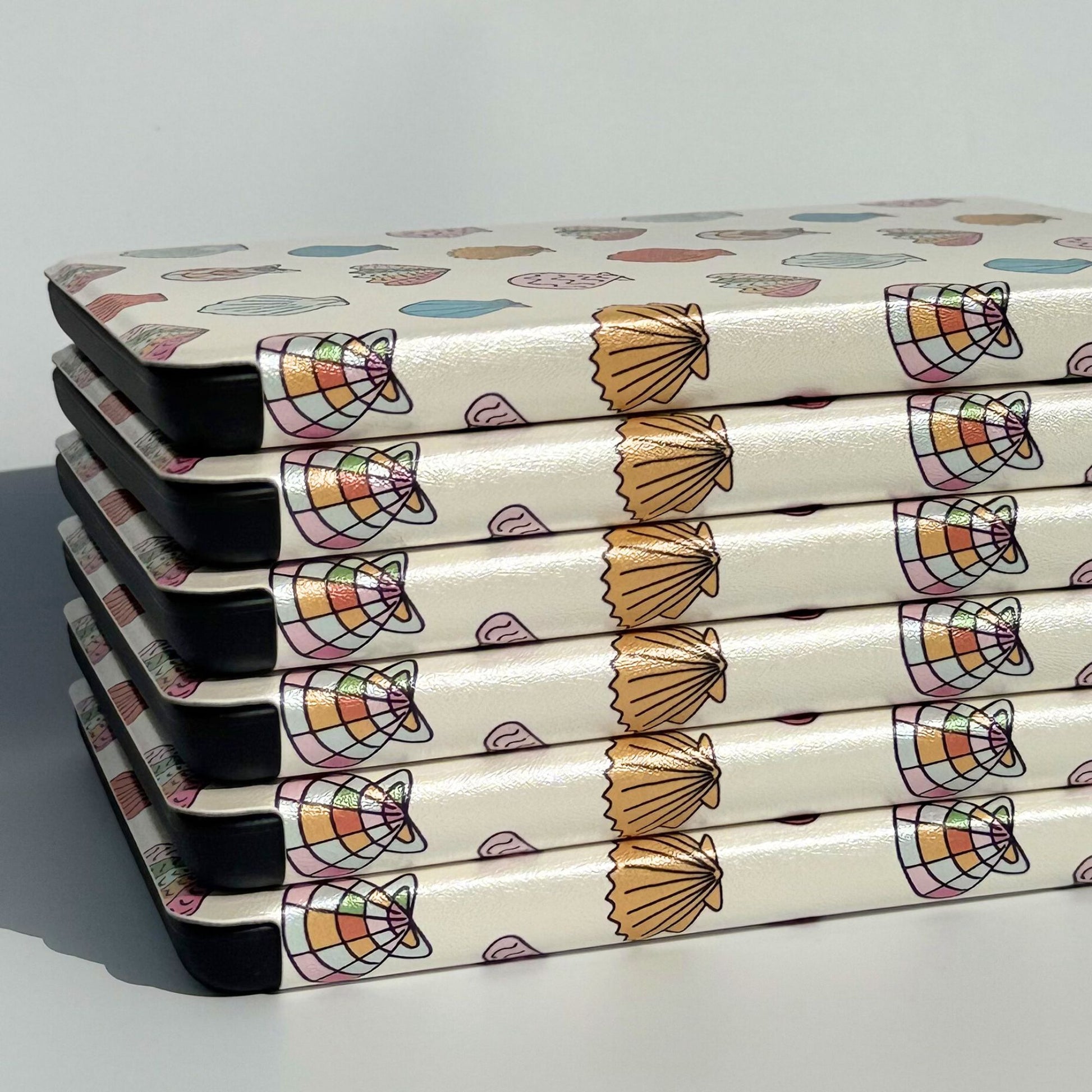 Stack of Shores Of Ophelia seashell Kindle cases — Case Society Australia