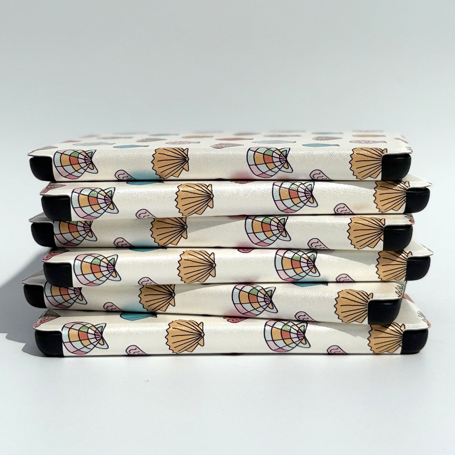 Side stack of Shores Of Ophelia seashell Kindle cases