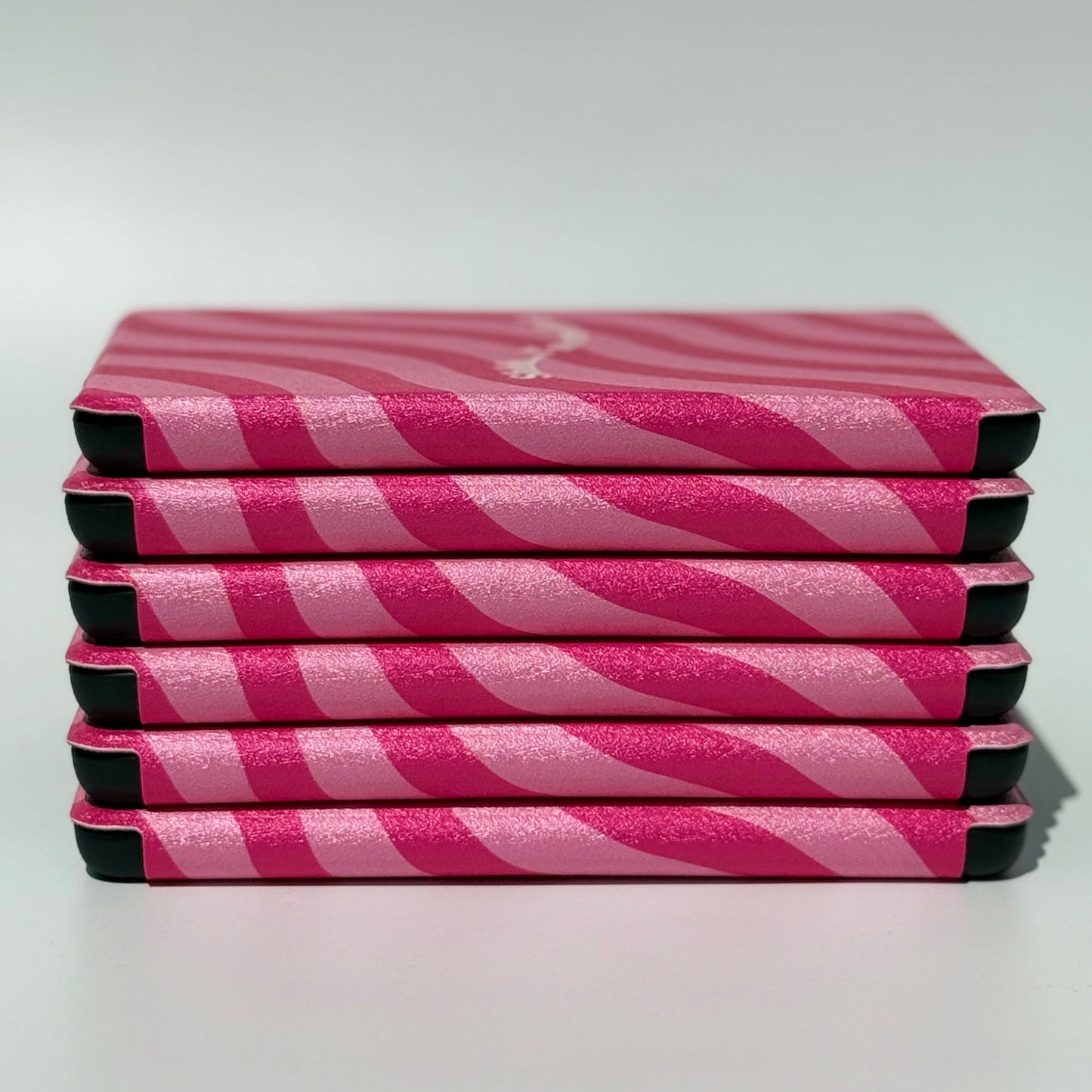 Stack of Shhh I'm Reading pink wavy stripe Kindle cases