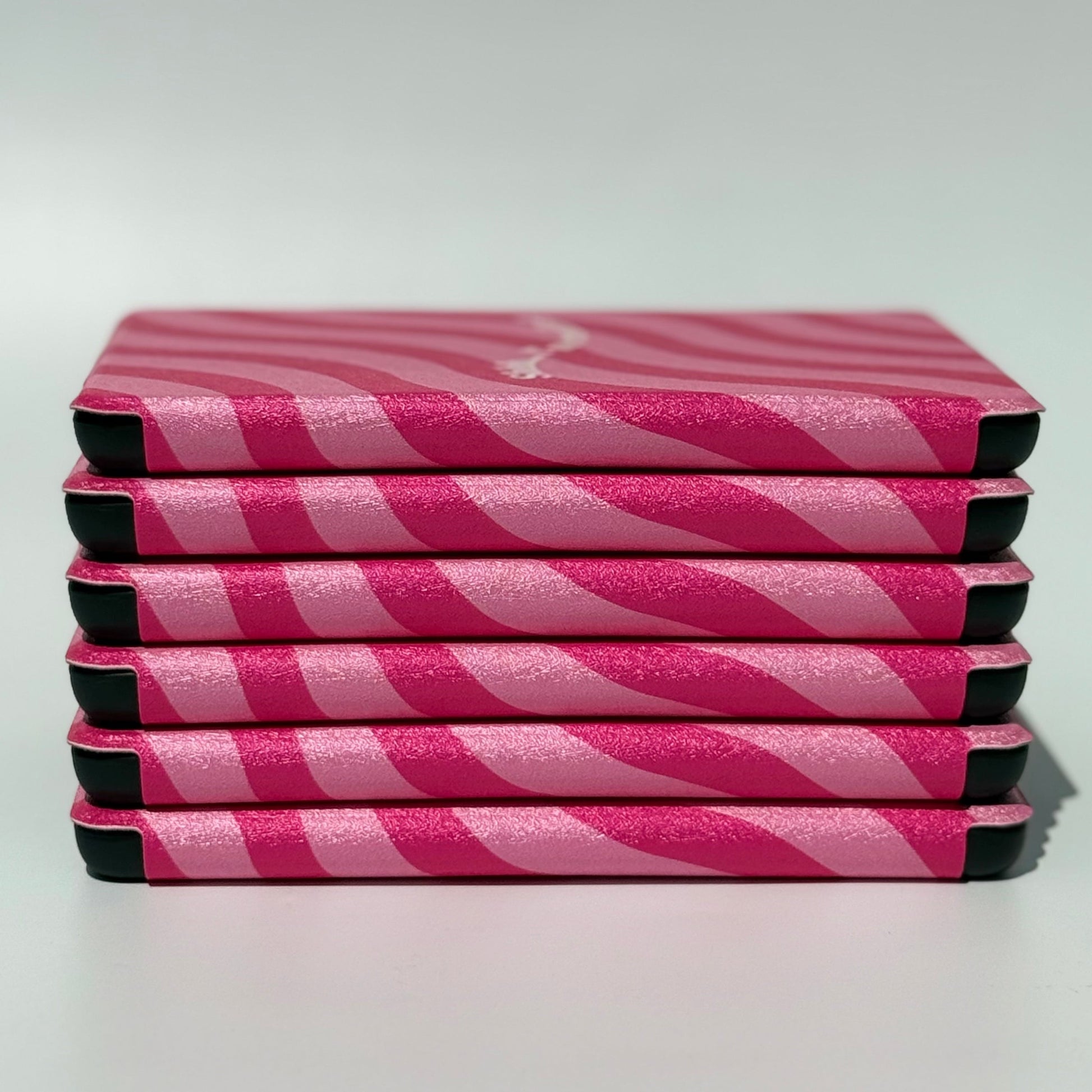 Stack of Shhh I'm Reading pink wavy stripe Kindle cases