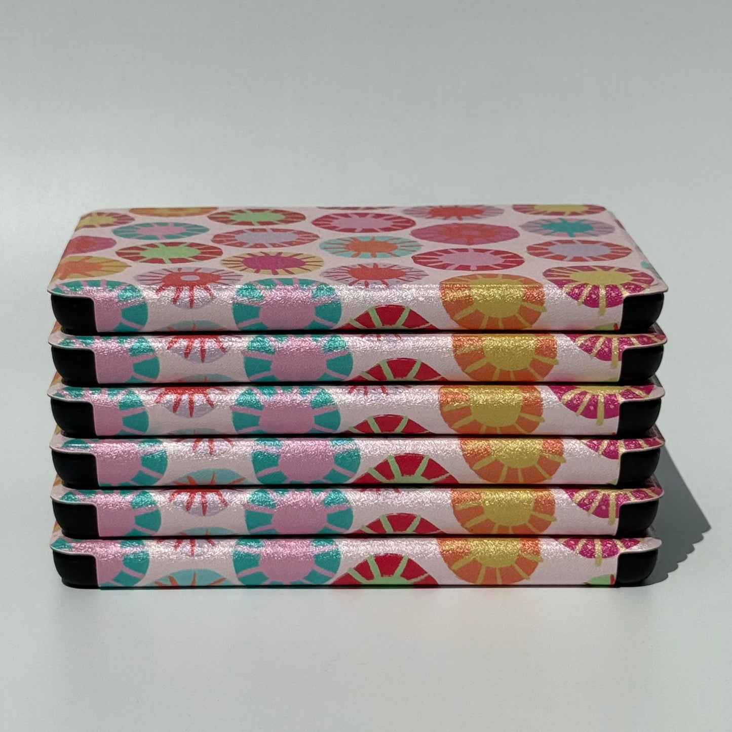 Sun Kissed Kindle Case - Stack of cases spine view