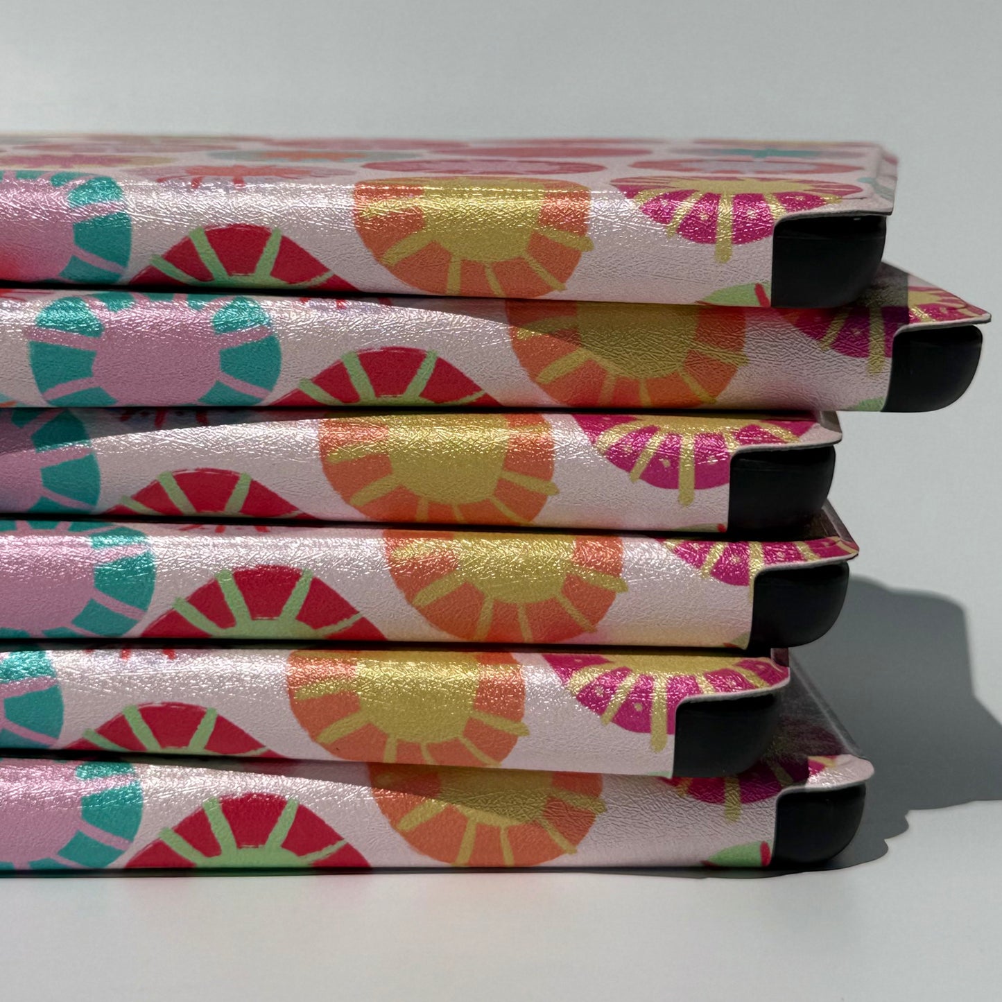 Sun Kissed Kindle Case - stack of cases up close of spines