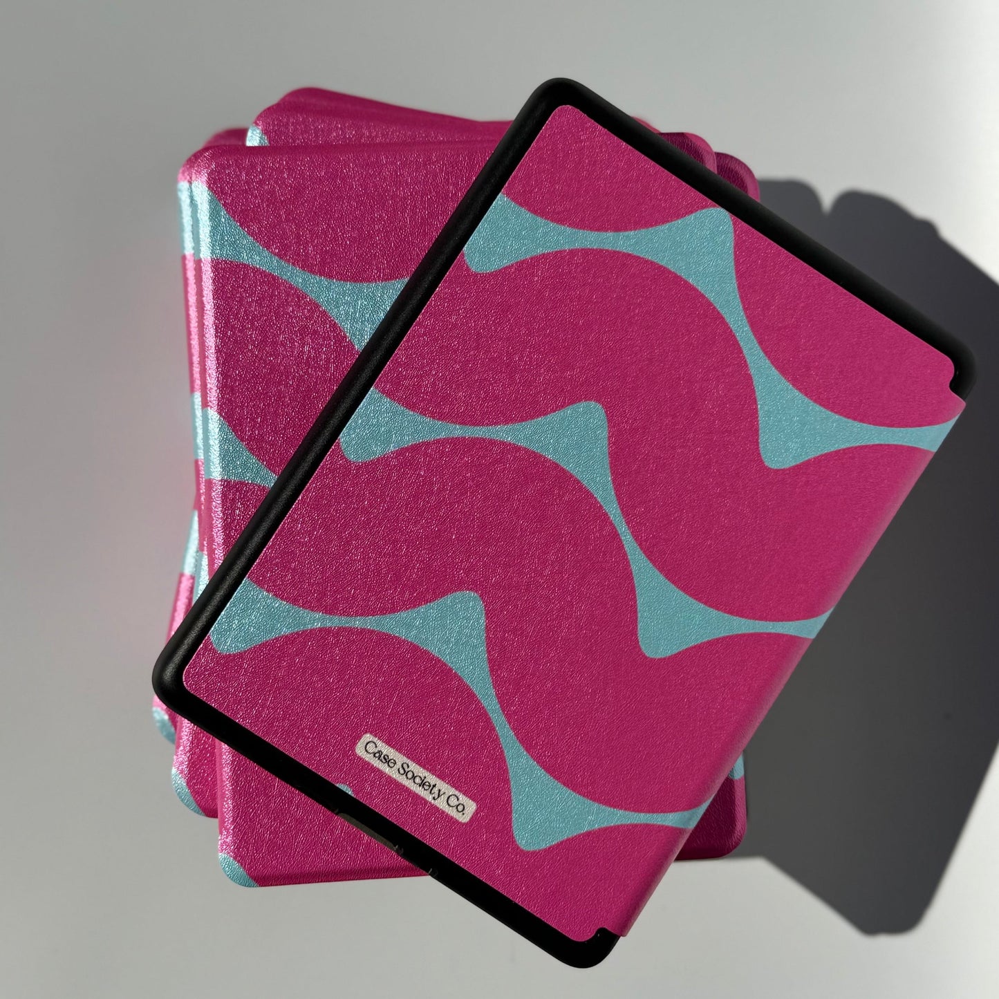 Angled Tidal Crush pink wavy book club Kindle cases showing the print