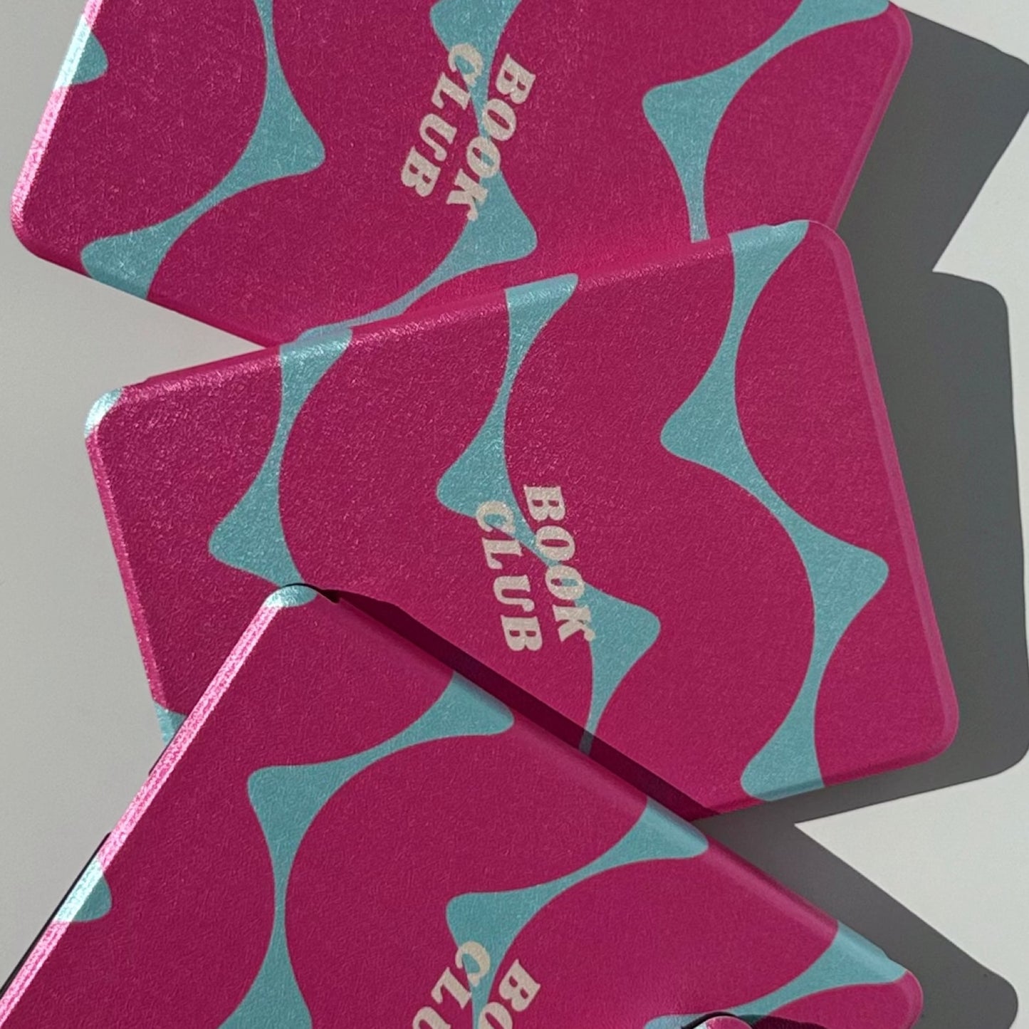 Tidal Crush Kindle case, magenta pink and teal wavy print with 'book club' lettering, bold pink Kindle cover