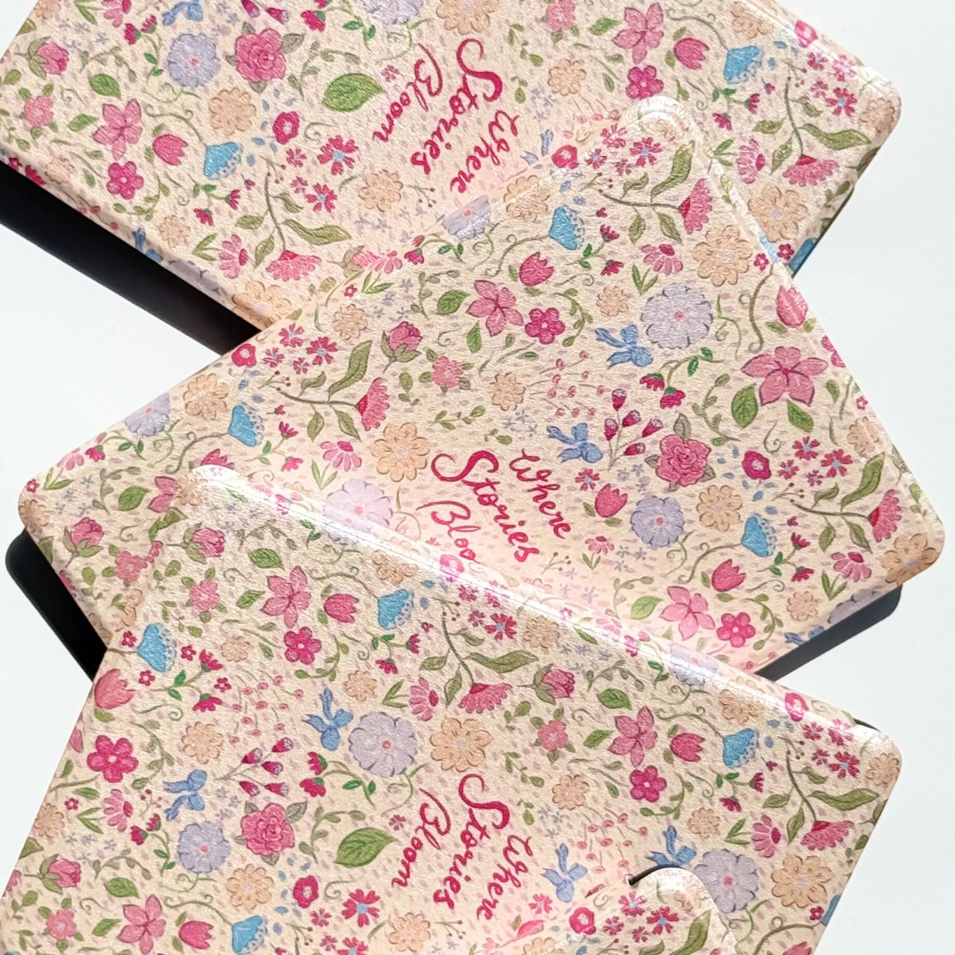 Pink floral Kindle Paperwhite case with vintage wildflower pattern and "Where Stories Bloom" script