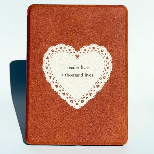 A Thousand Lives Kindle case standing upright in tan brown with a white lace heart, Case Society Co