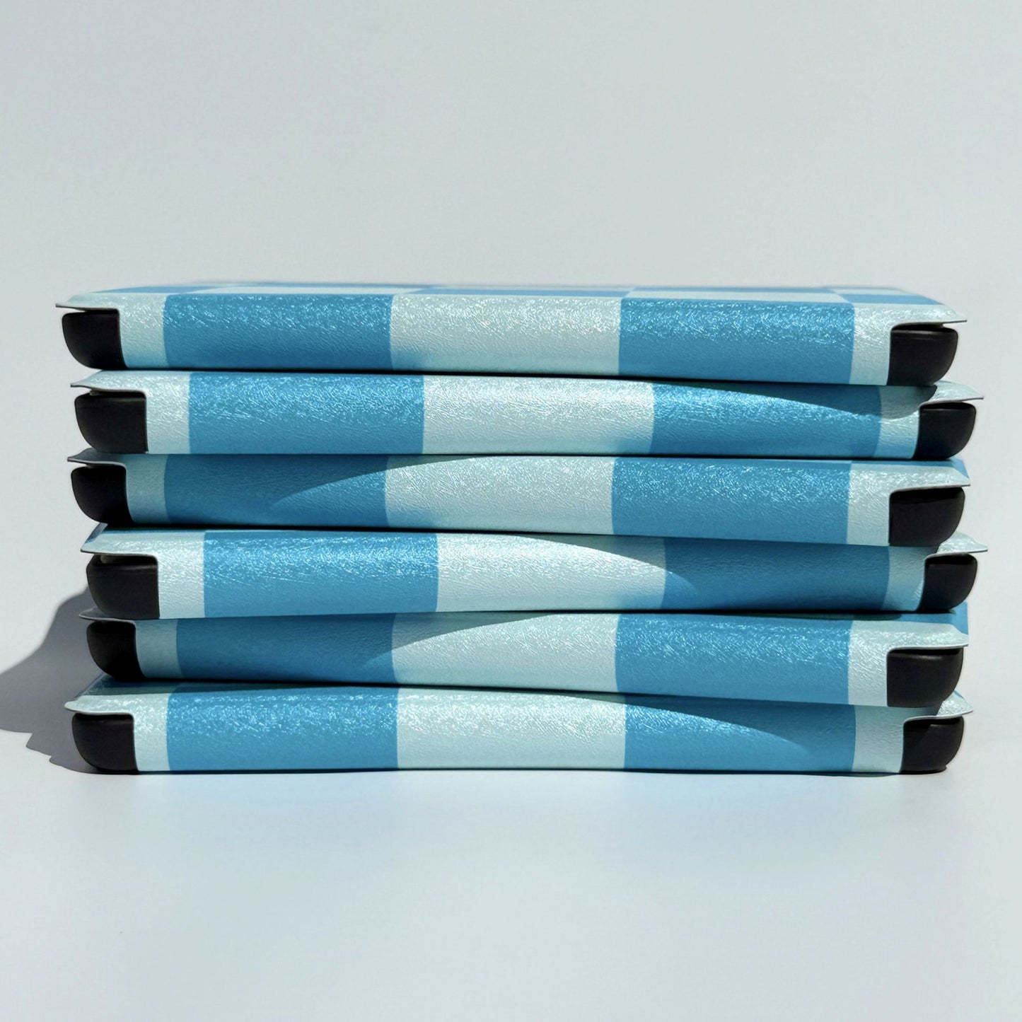 Cute blue on blue check Kindle cases in a neat side stack