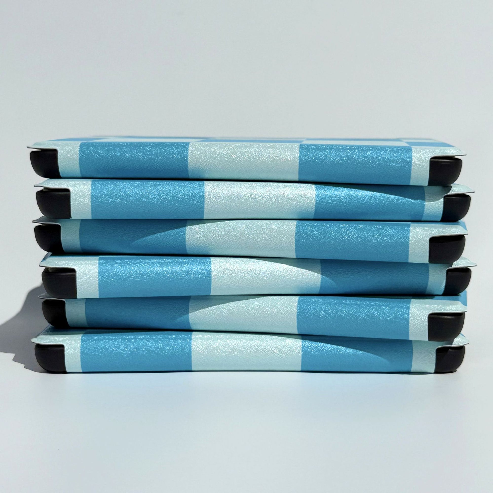 Cute blue on blue check Kindle cases in a neat side stack