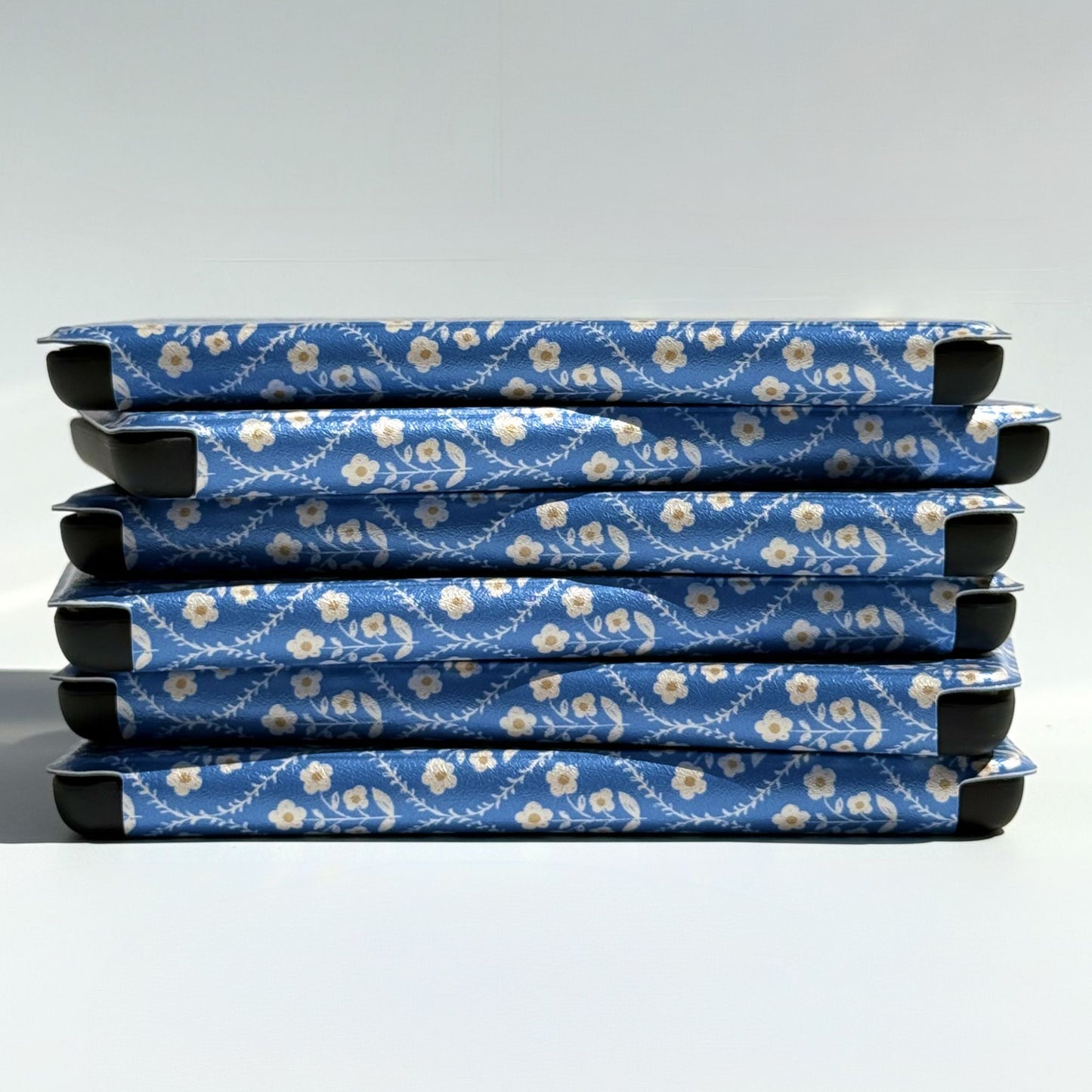 Blue floral Kobo cases stacked on their sides showing the folio spine, shipped from Australia