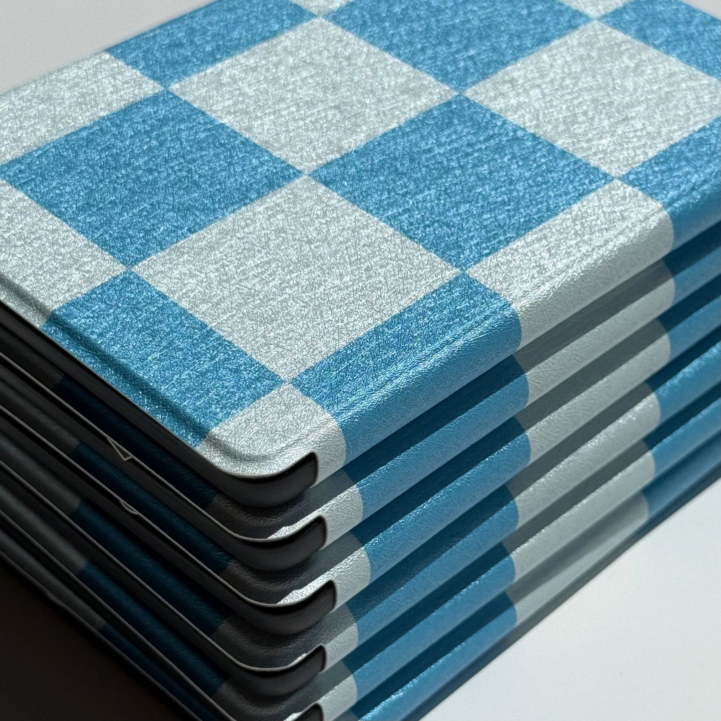 Detail of the tonal blue gingham check pattern on a Kindle case