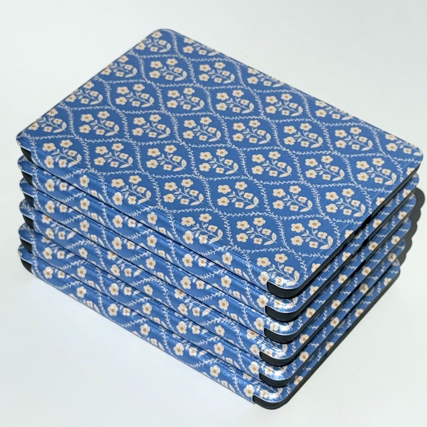 Bluebell blue floral Kindle cases stacked at angles, showing the soft vintage print on every cover